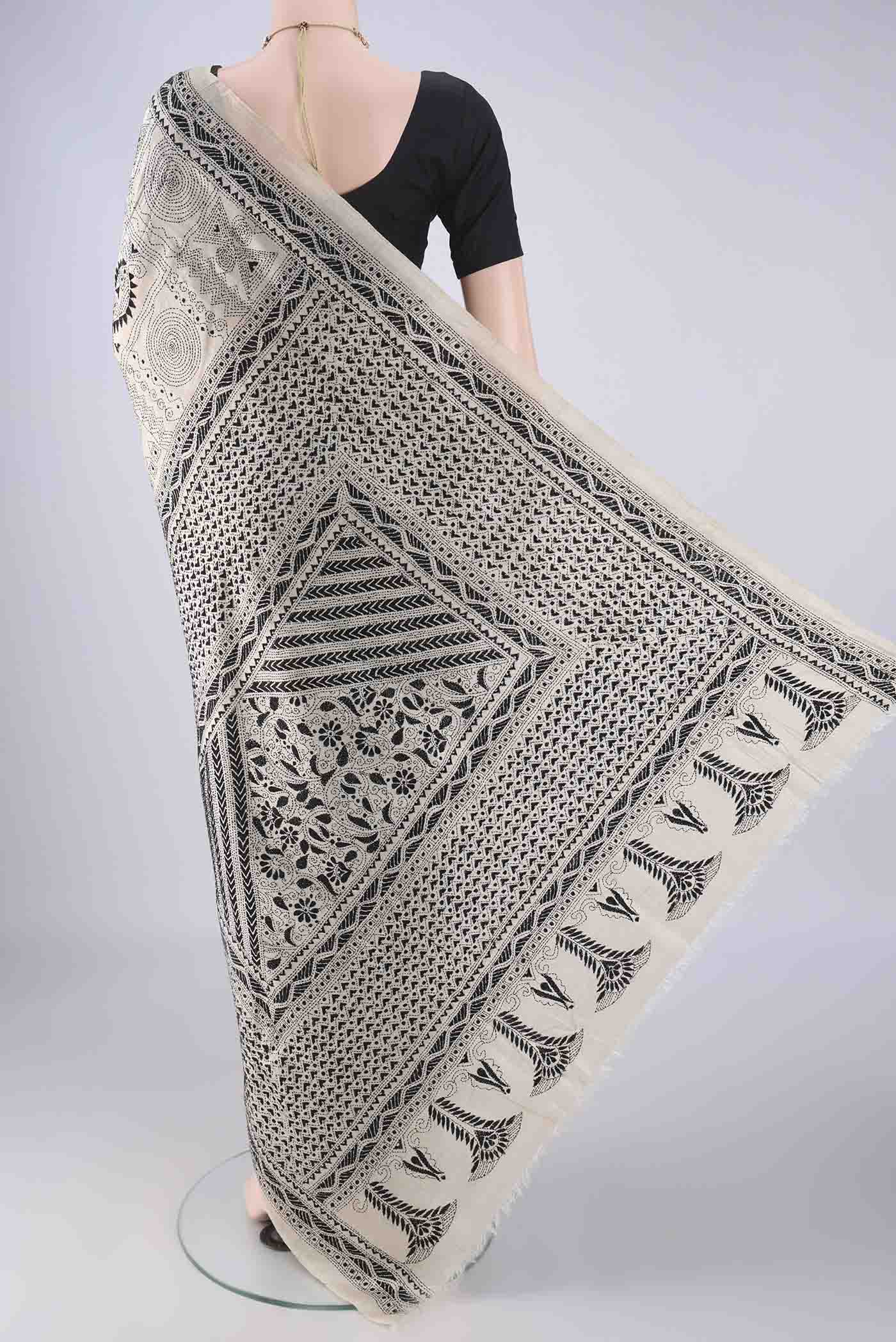 Flat view of Beige Tussar Silk Saree with Kantha Work on the body and Thread Border. 