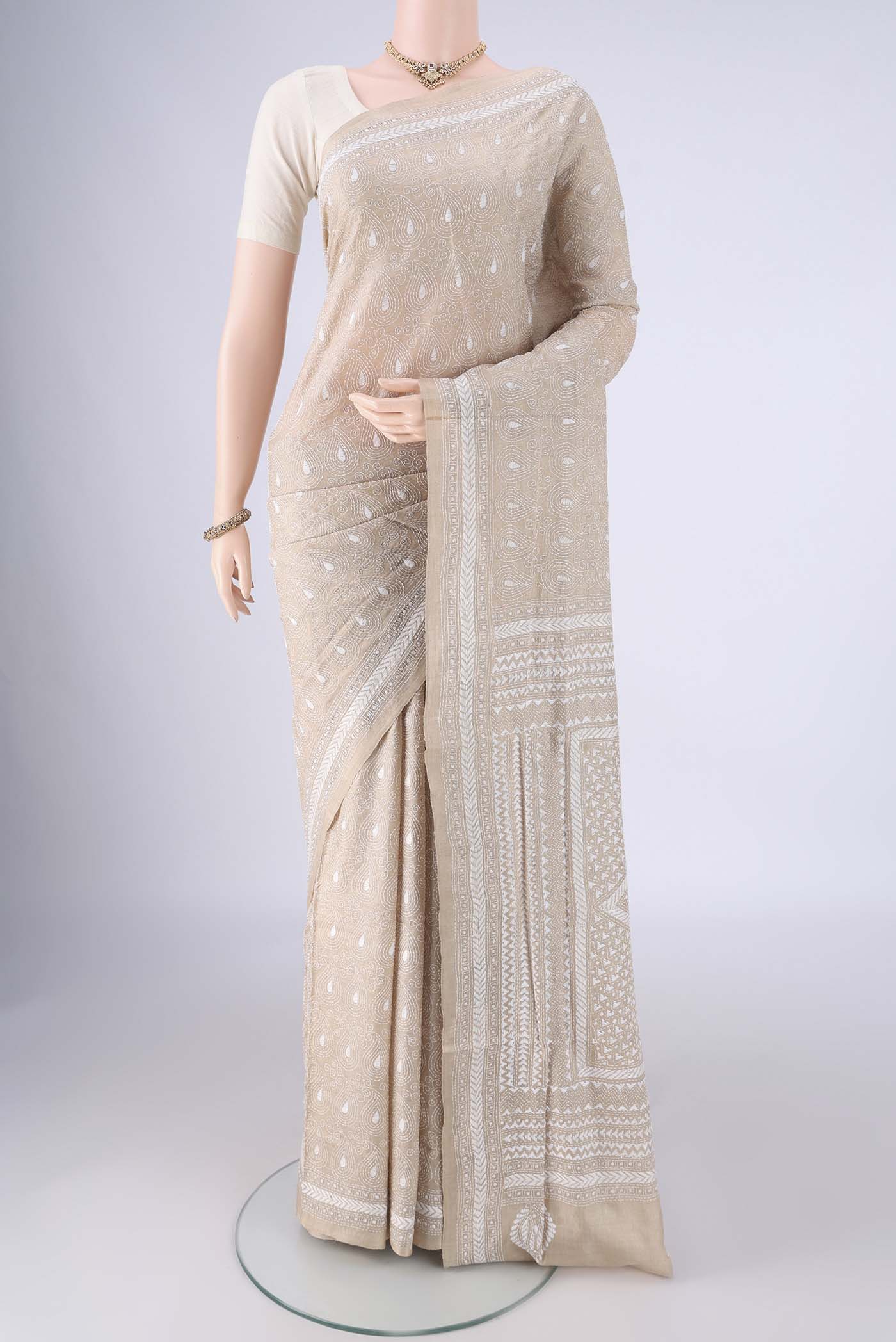 Beige Tussar Silk Saree with Kantha Work on the body and Thread Border.  displayed on a mannequin