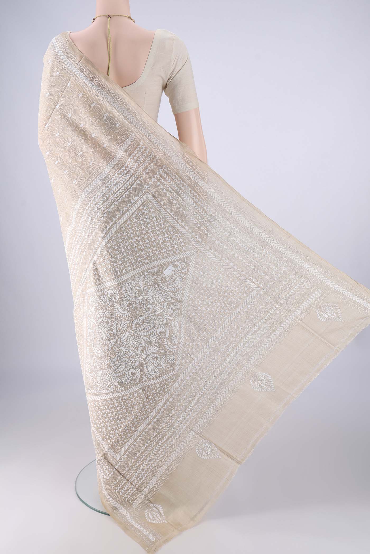 Flat view of Beige Tussar Silk Saree with Kantha Work on the body and Thread Border. 