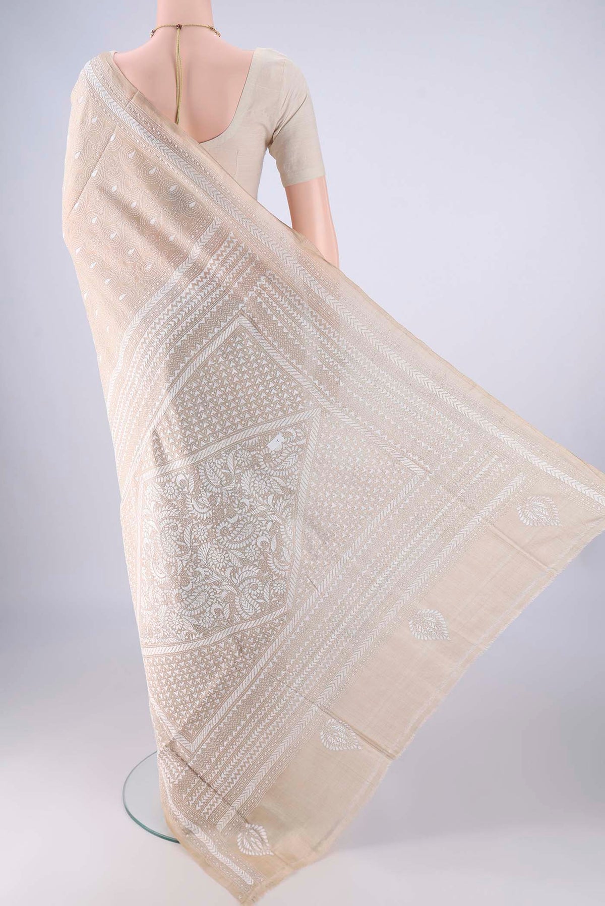 Flat view of Beige Tussar Silk Saree with Kantha Work on the body and Thread Border. 