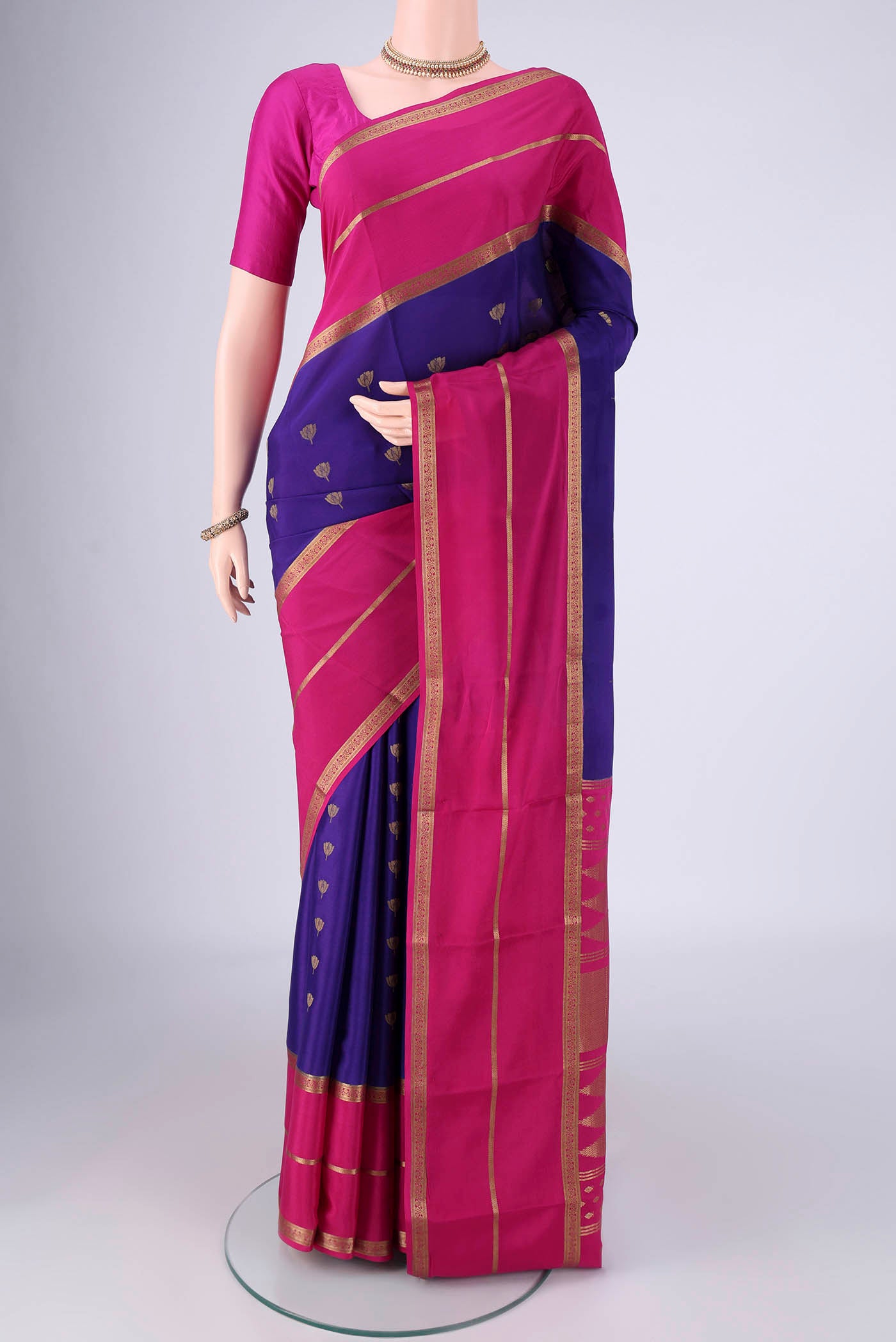 Blue Mysore Crepe Saree with Zari Butta on the body and Zari Border.  displayed on a mannequin