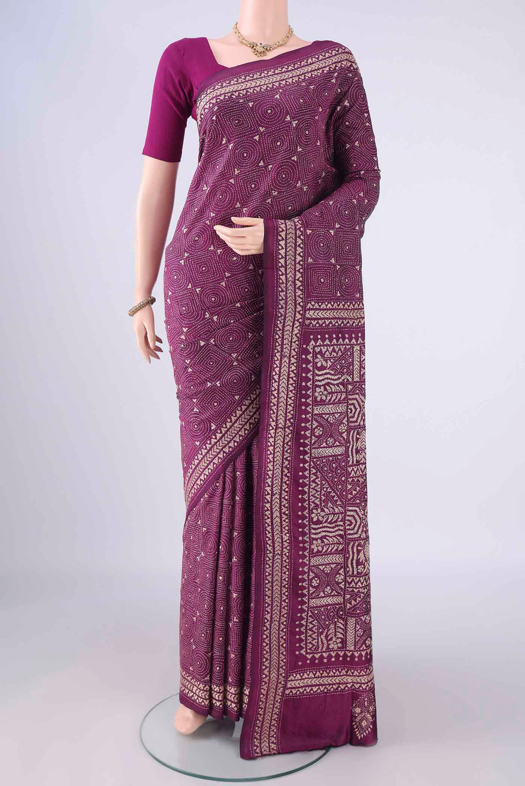 Magenta Kantha Silk Saree with Kantha Work on the body and Thread Border.  displayed on a mannequin