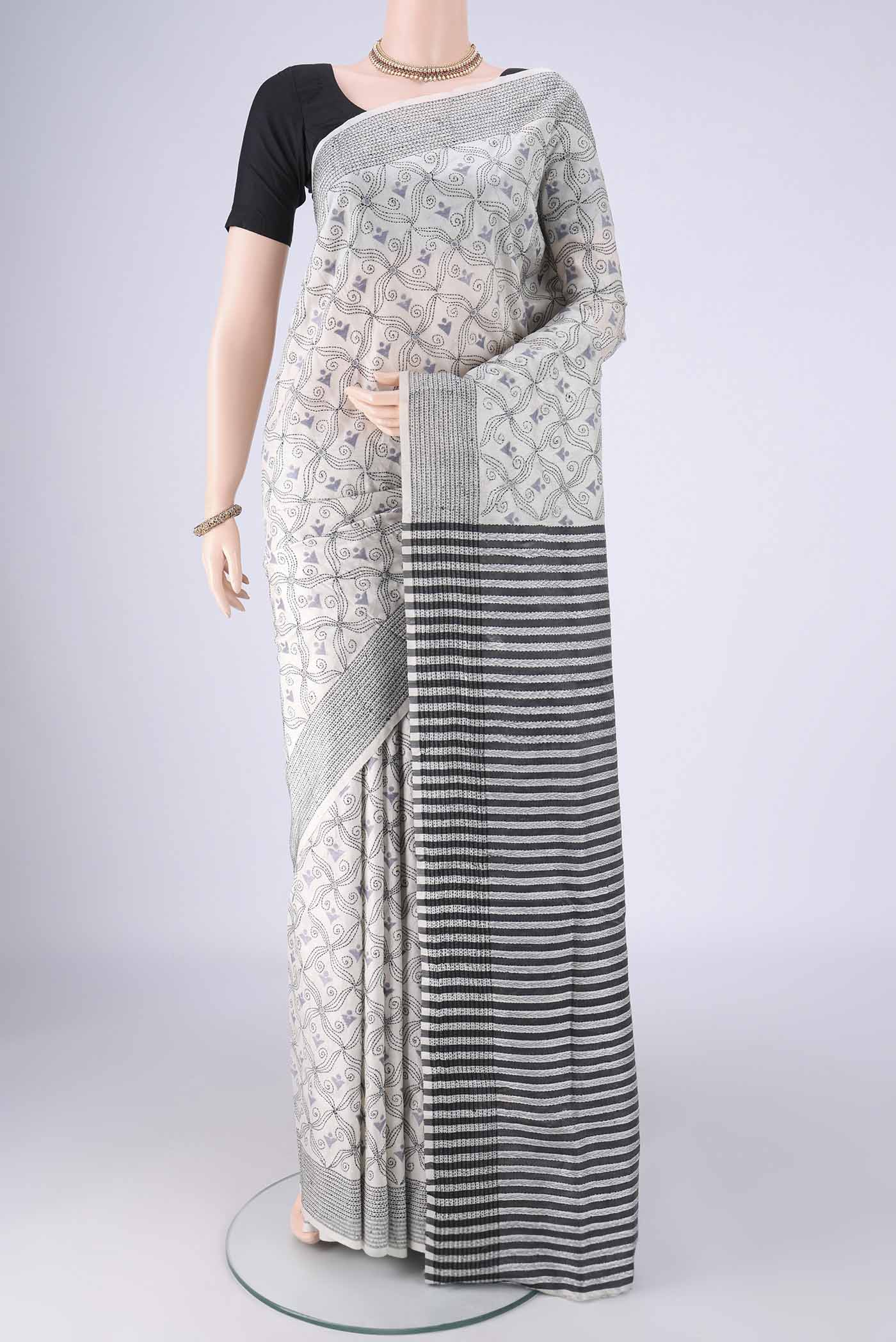White Kantha Silk Saree with Kantha Work on the body and Thread Border.  displayed on a mannequin