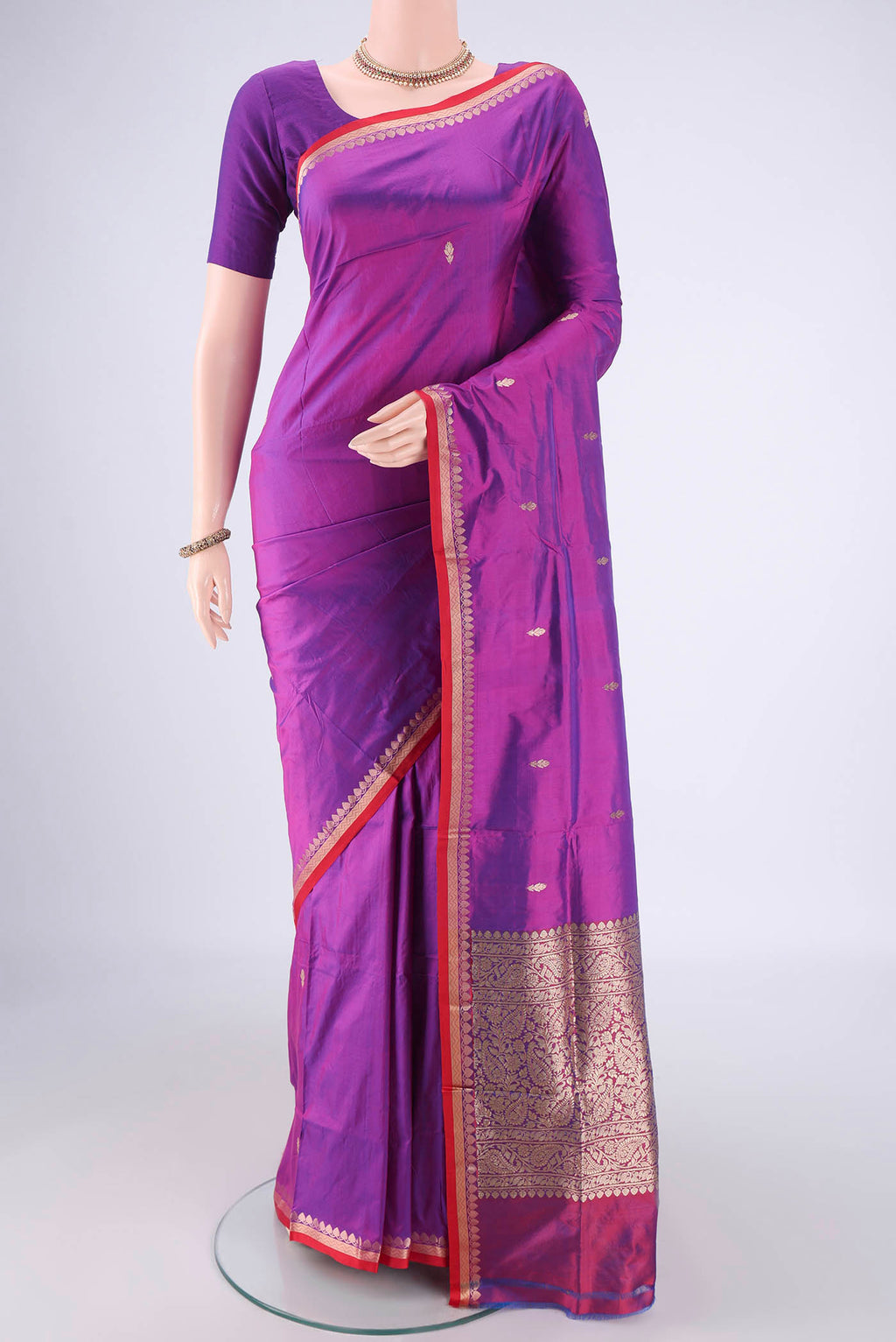 Magenta Banarasi Katan Silk Saree with Zari Butta on the body and Zari Border.  displayed on a mannequin