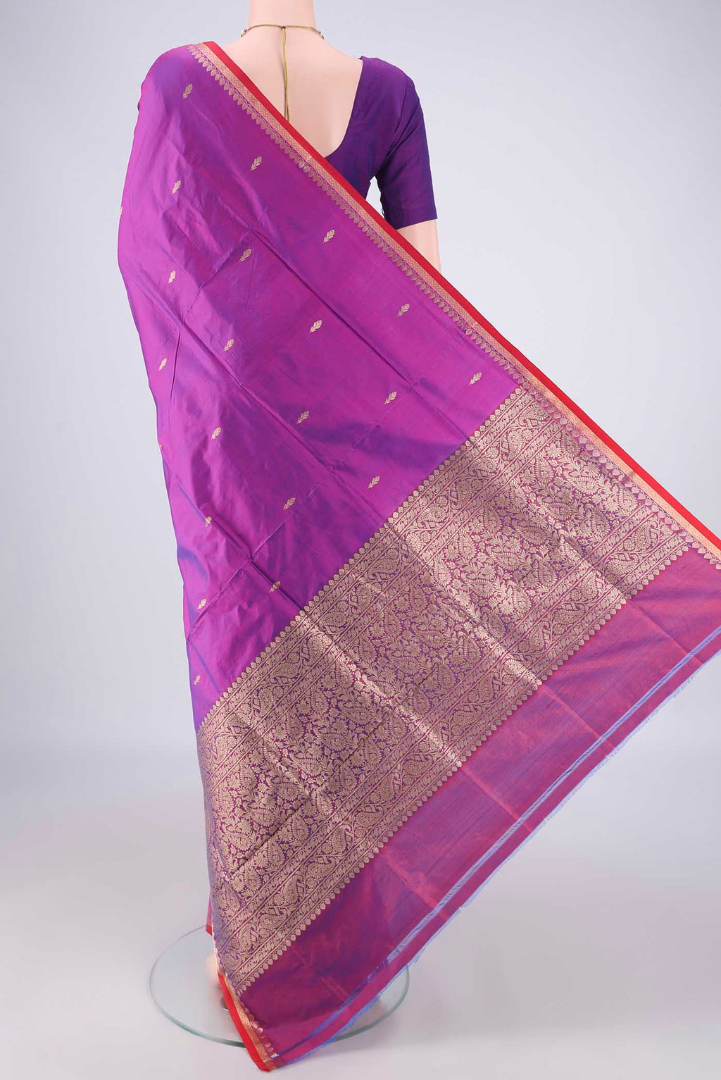 Flat view of Magenta Banarasi Katan Silk Saree with Zari Butta on the body and Zari Border. 
