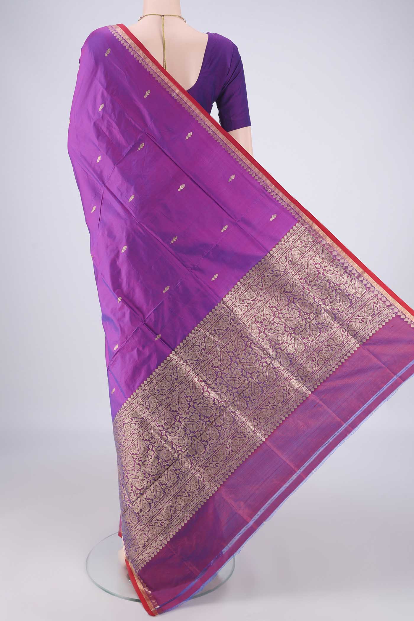 Flat view of Magenta Banarasi Katan Silk Saree with Zari Butta on the body and Zari Border. 
