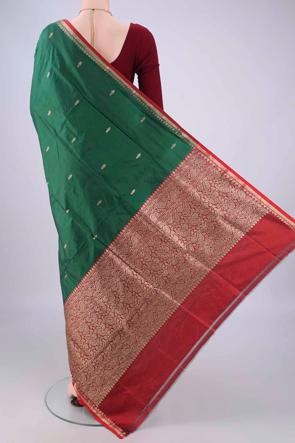 Flat view of Bottle Green Banarasi Katan Silk Saree with Zari Butta on the body and Zari Border. 