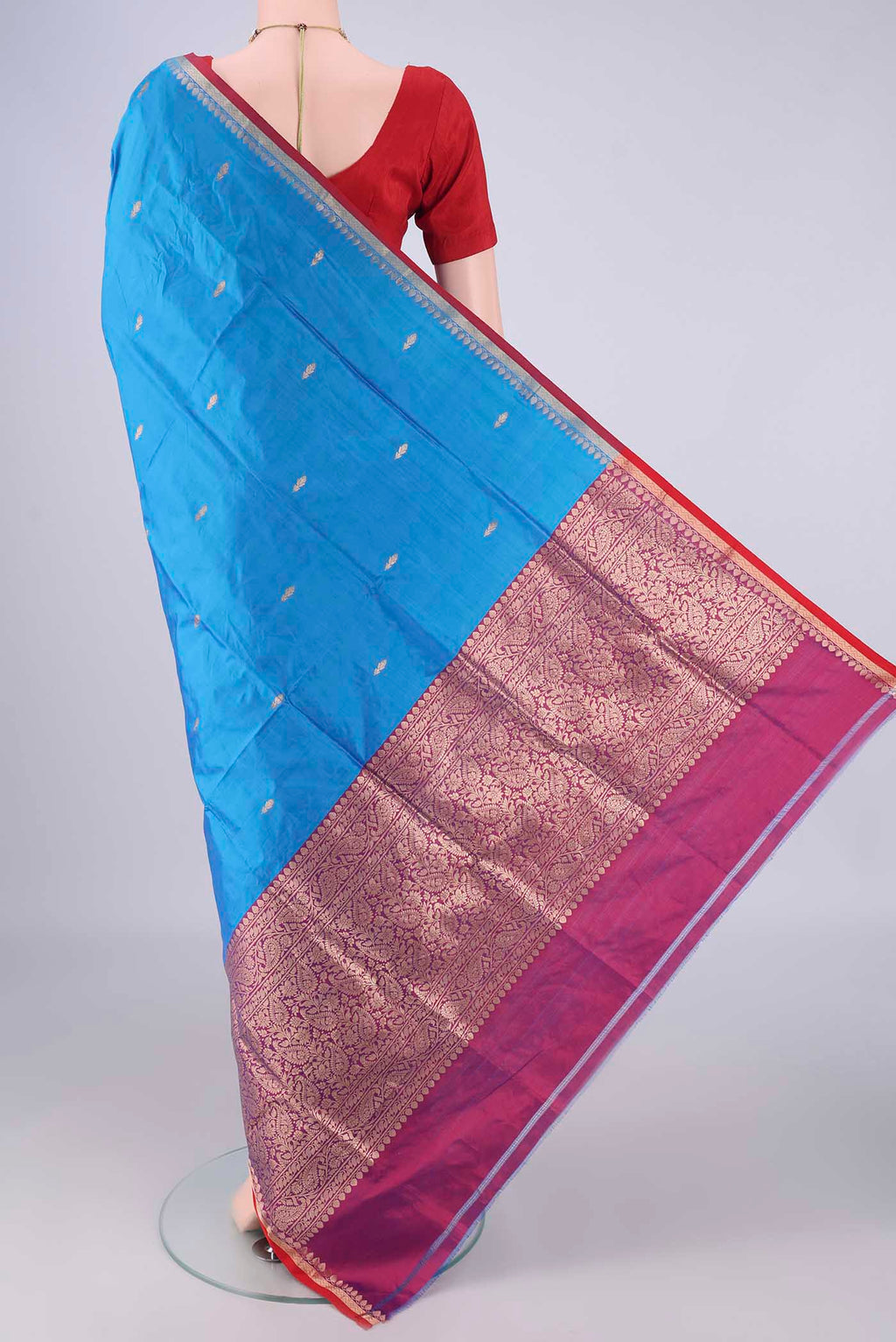Flat view of Blue Banarasi Katan Silk Saree with Zari Butta on the body and Zari Border. 
