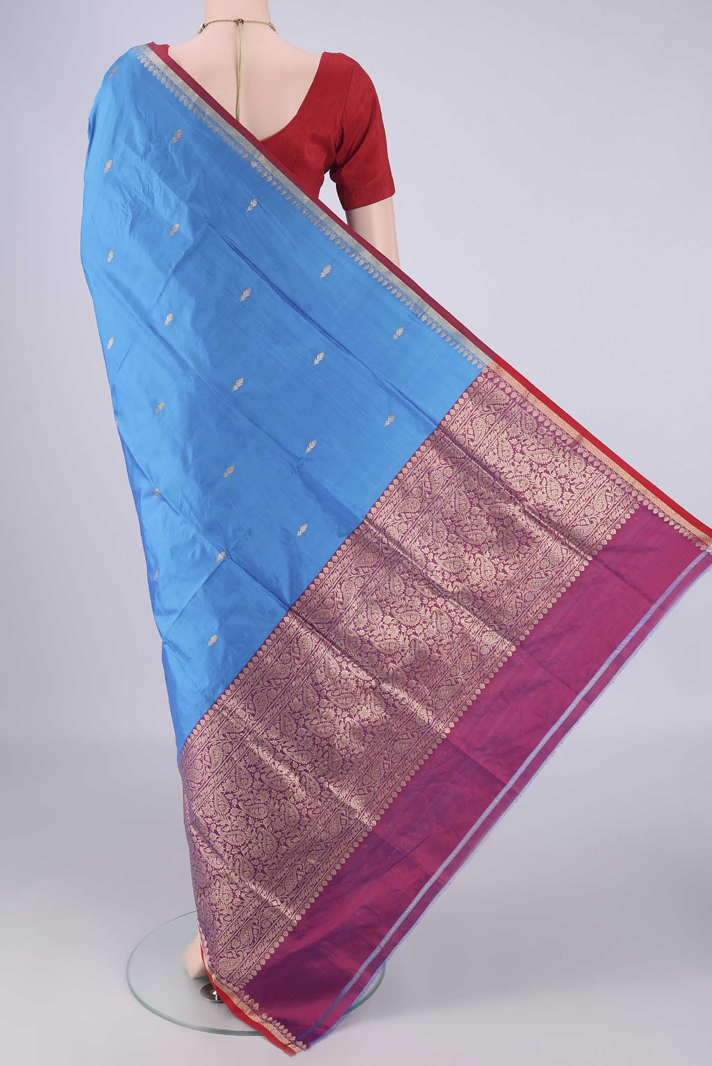 Flat view of Blue Banarasi Katan Silk Saree with Zari Butta on the body and Zari Border. 