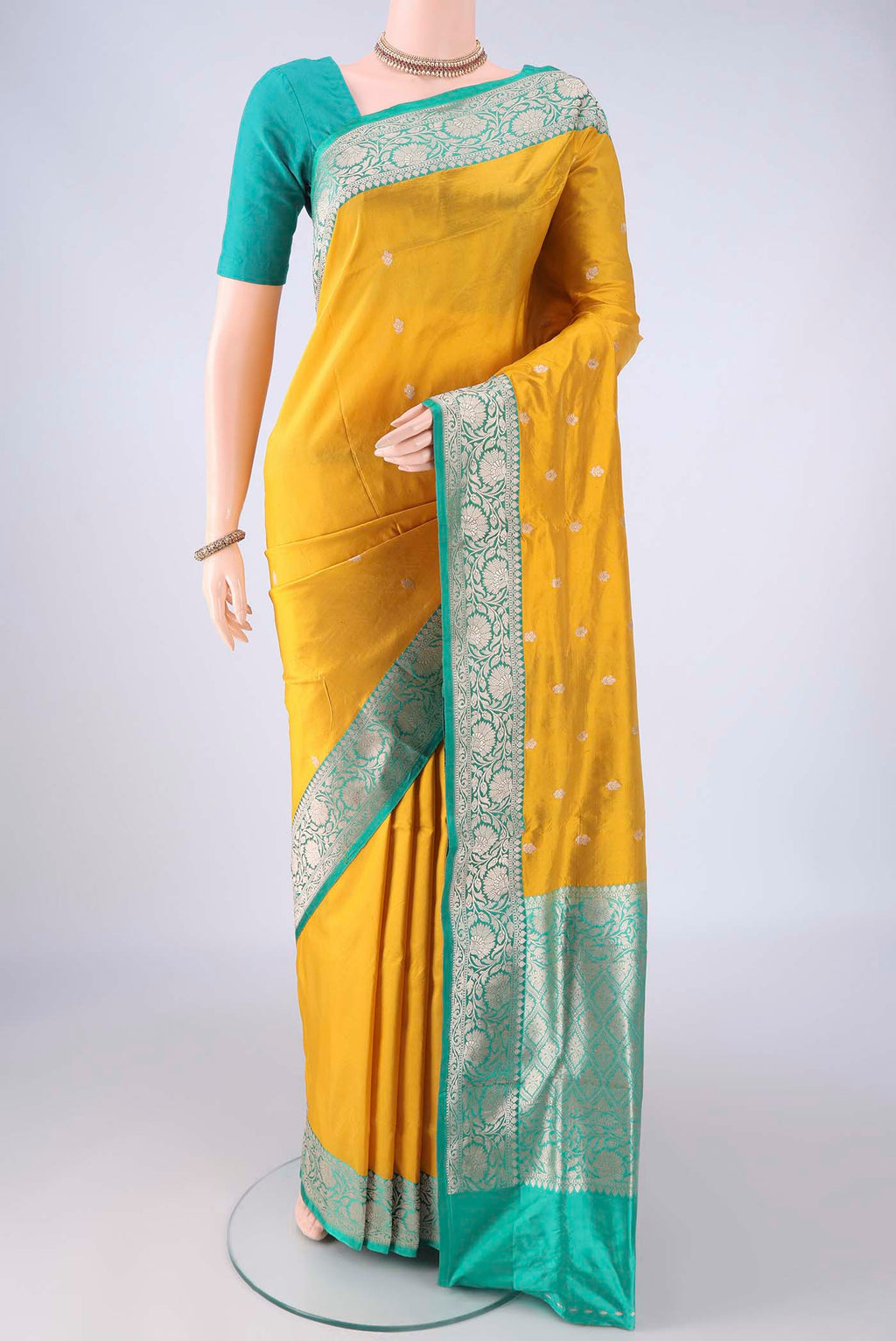 Yellow Banarasi Katan Silk Saree with Zari Butta on the body and Zari Border.  displayed on a mannequin