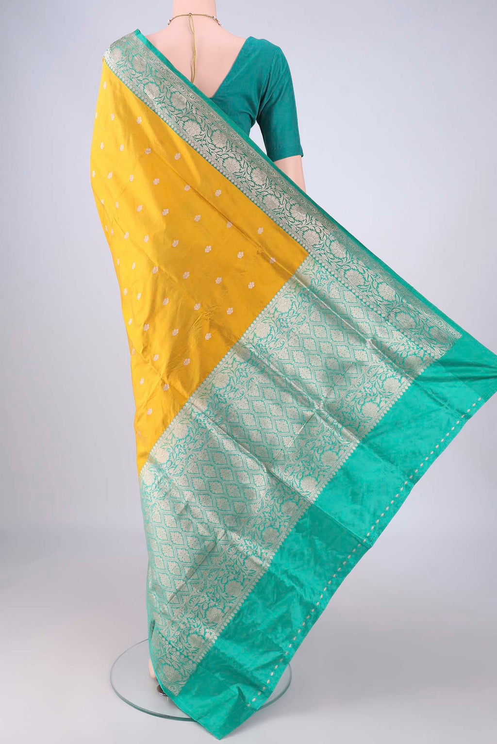 Flat view of Yellow Banarasi Katan Silk Saree with Zari Butta on the body and Zari Border. 