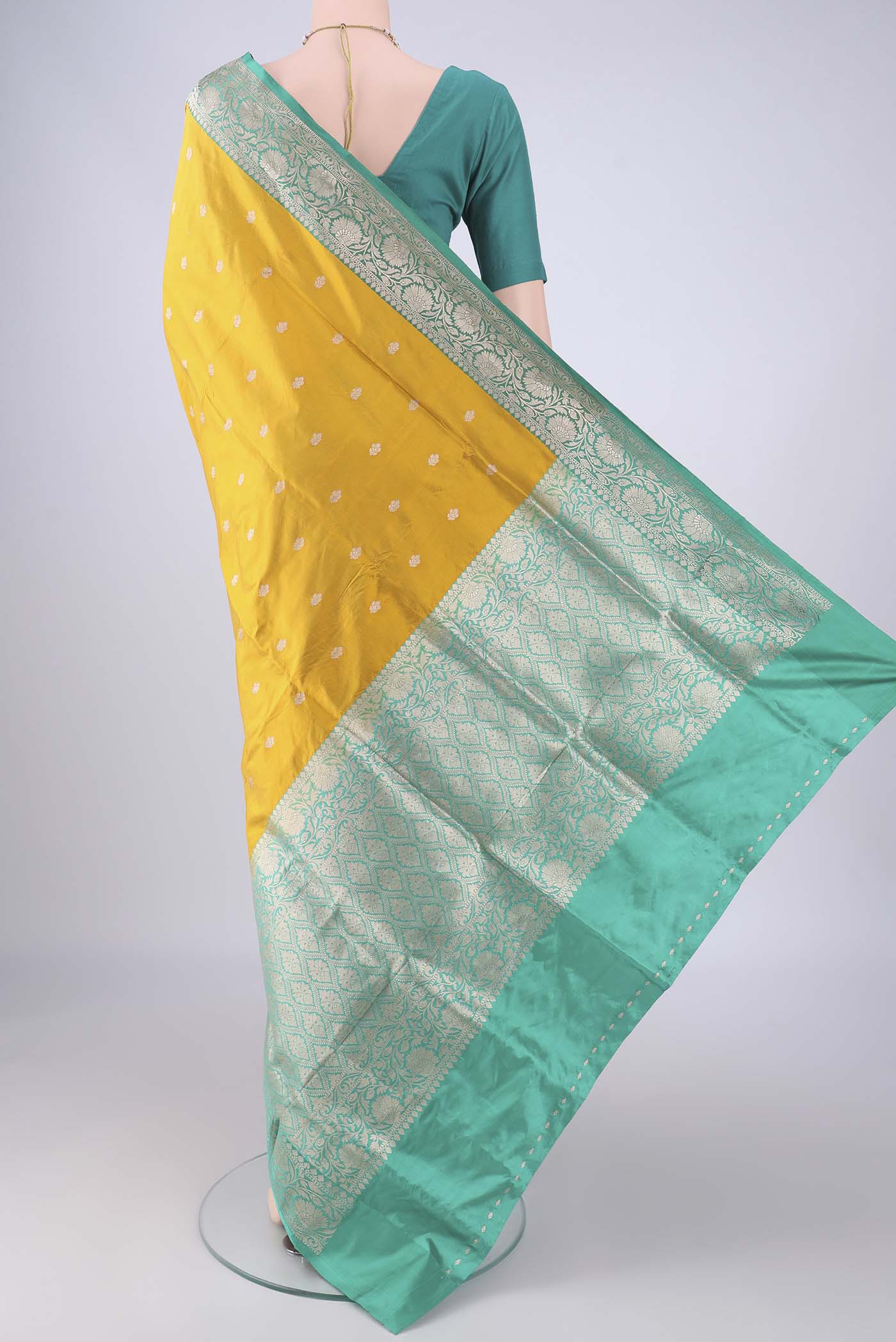 Flat view of Yellow Banarasi Katan Silk Saree with Zari Butta on the body and Zari Border. 