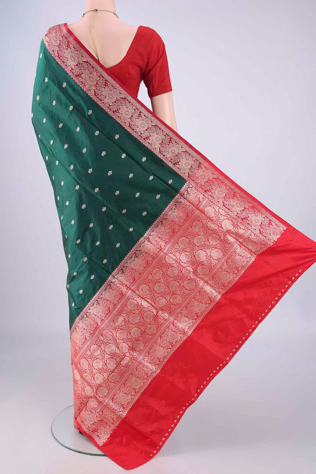 Flat view of Bottle Green Banarasi Katan Silk Saree with Zari Butta on the body and Zari Border. 