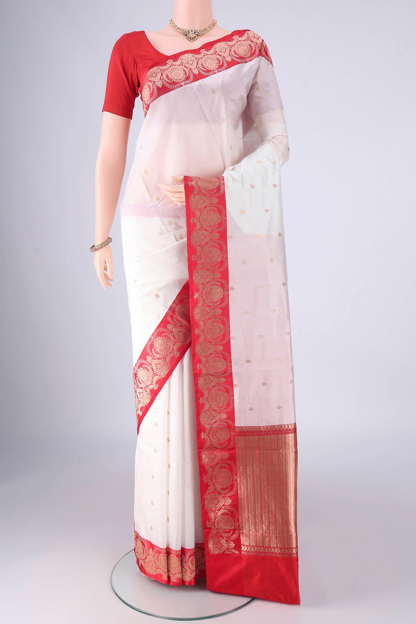 White Banarasi Katan Silk Saree with Zari Butta on the body and Zari Border.  displayed on a mannequin
