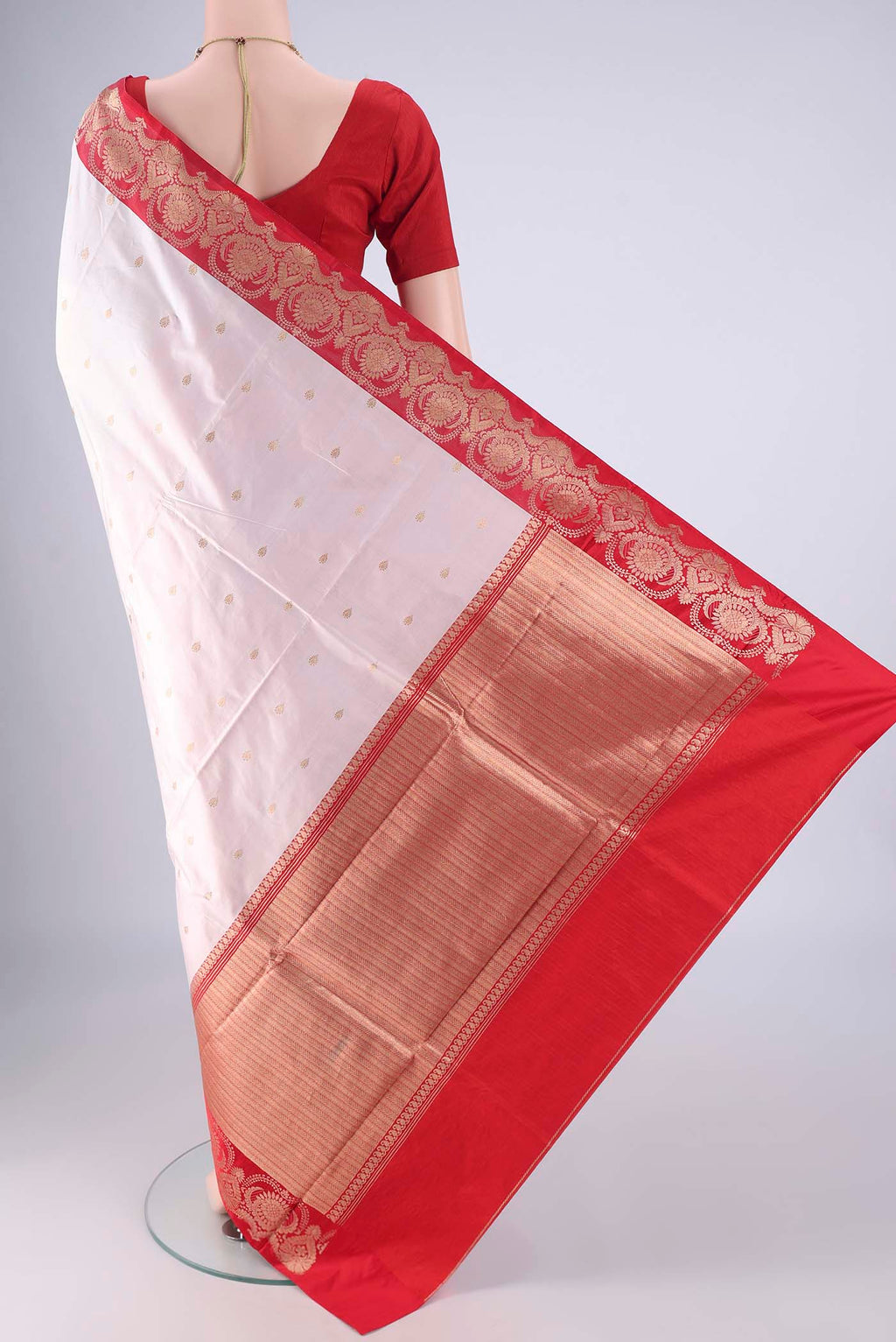 Flat view of White Banarasi Katan Silk Saree with Zari Butta on the body and Zari Border. 