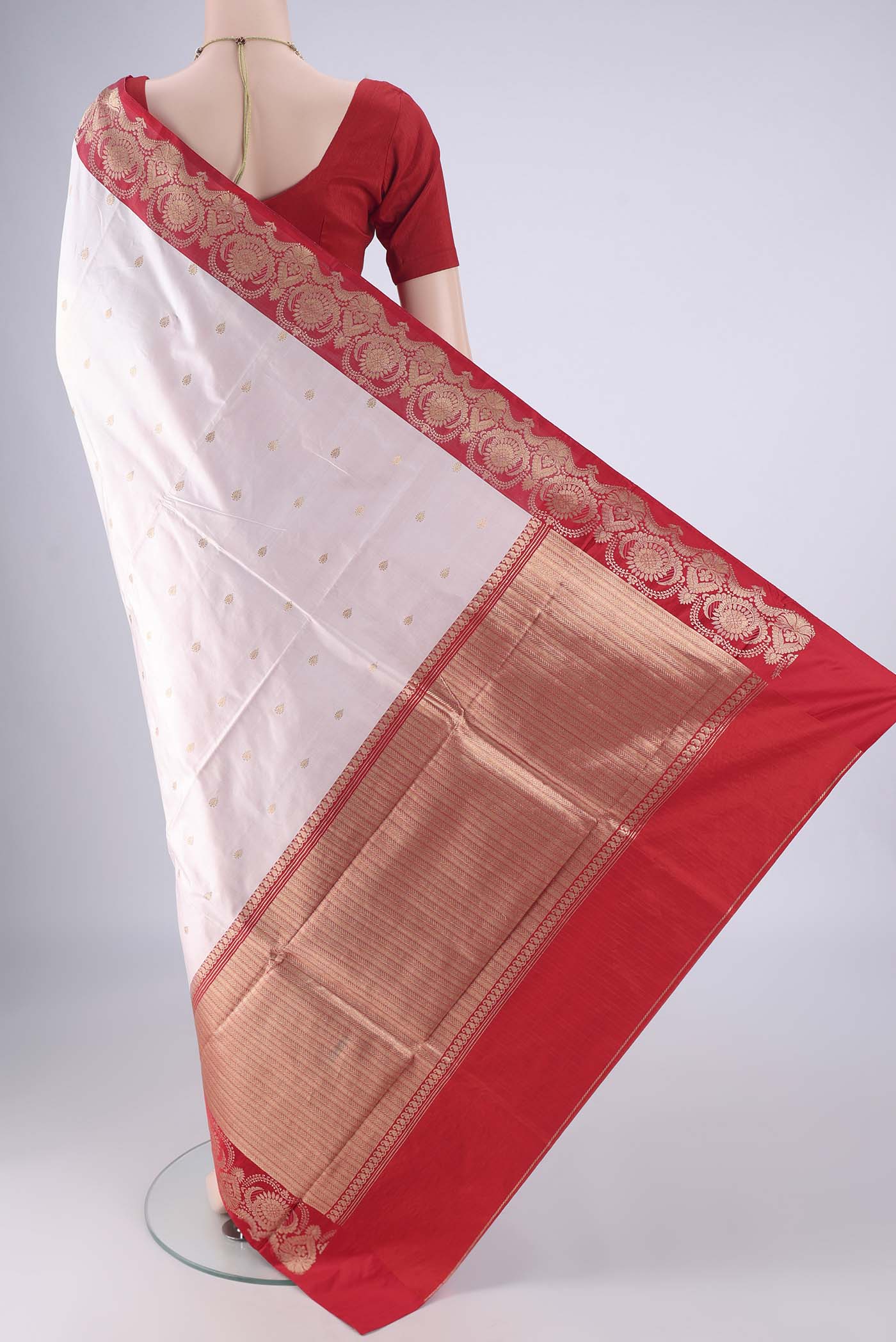 Flat view of White Banarasi Katan Silk Saree with Zari Butta on the body and Zari Border. 