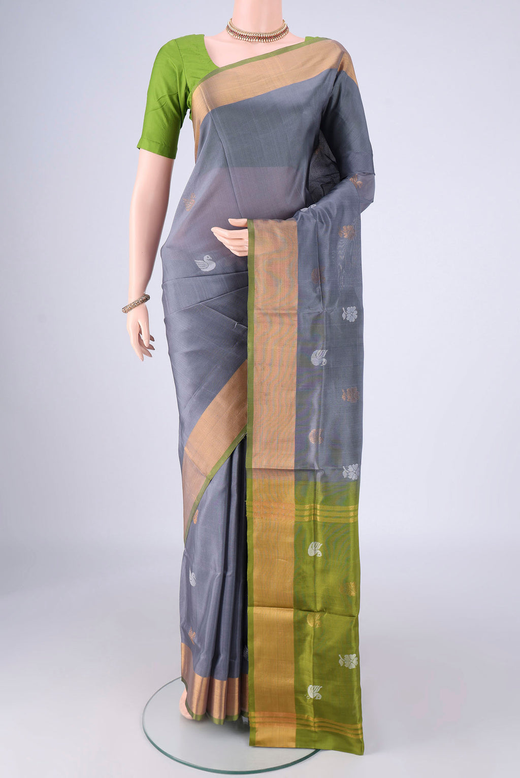 Grey Uppada Silk Saree with Zari And Thread Butta on the body and Zari Border.  displayed on a mannequin