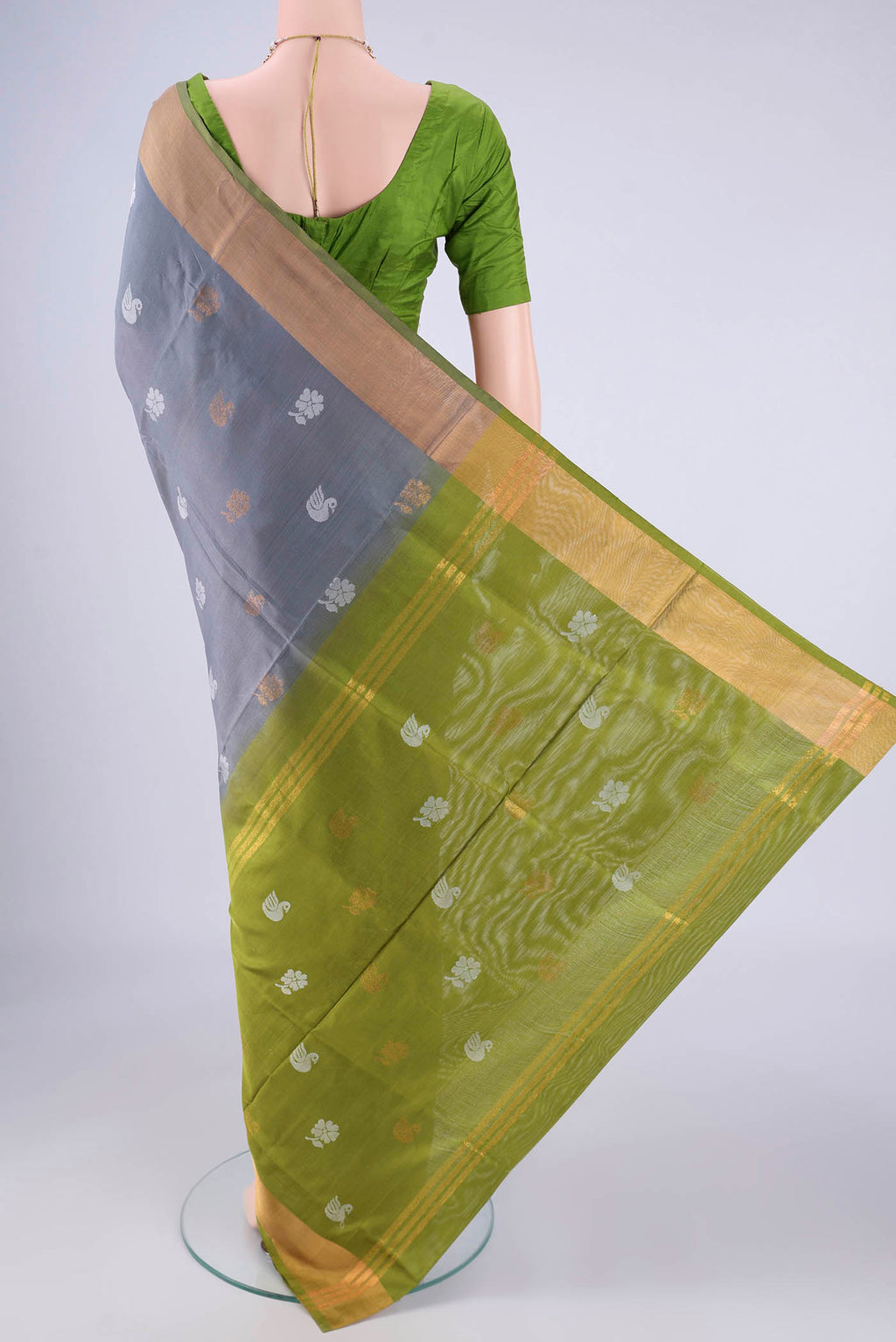 Flat view of Grey Uppada Silk Saree with Zari And Thread Butta on the body and Zari Border. 