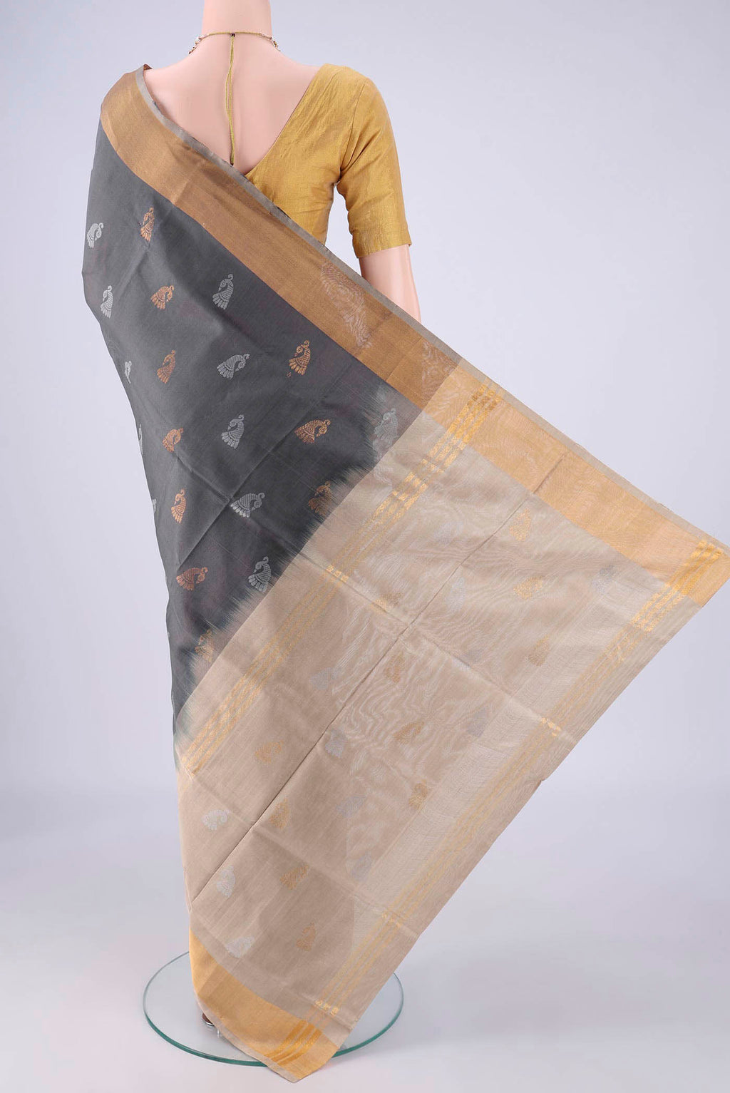 Flat view of Grey Uppada Silk Saree with Zari And Thread Butta on the body and Zari Border. 