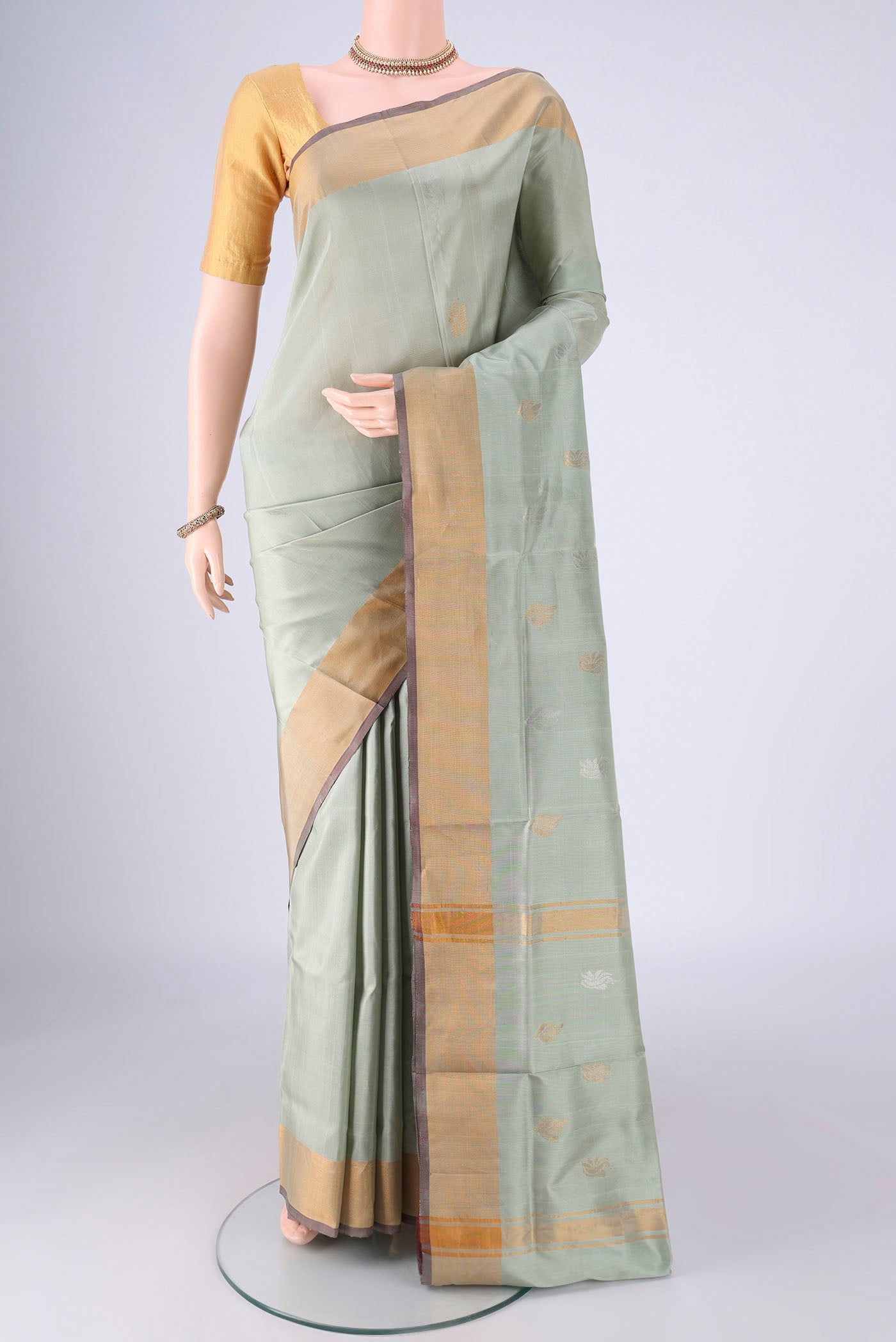 Lilac Uppada Silk Saree with Zari And Thread Butta on the body and Zari Border.  displayed on a mannequin