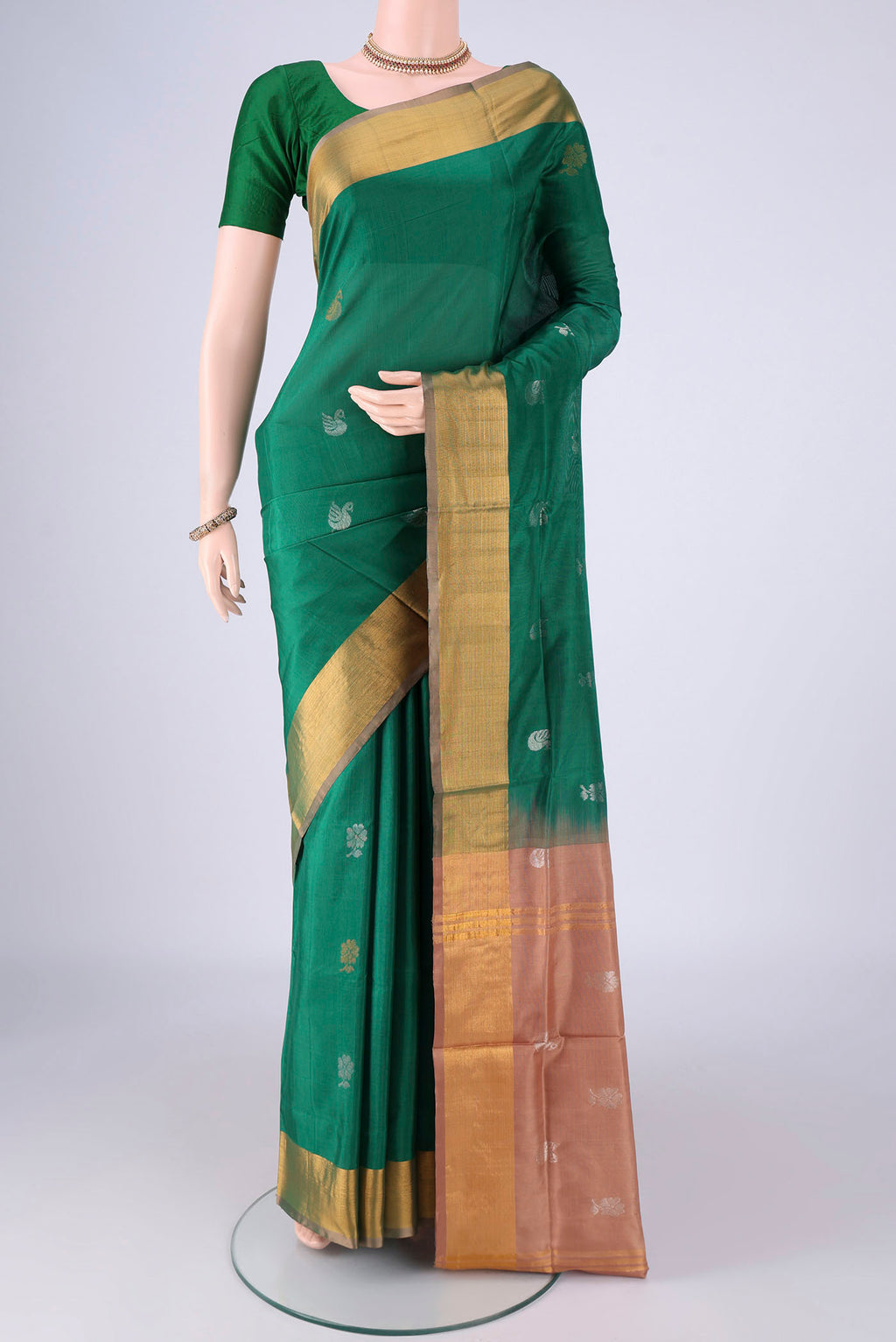 Green Uppada Silk Saree with Zari And Thread Butta on the body and Zari Border.  displayed on a mannequin