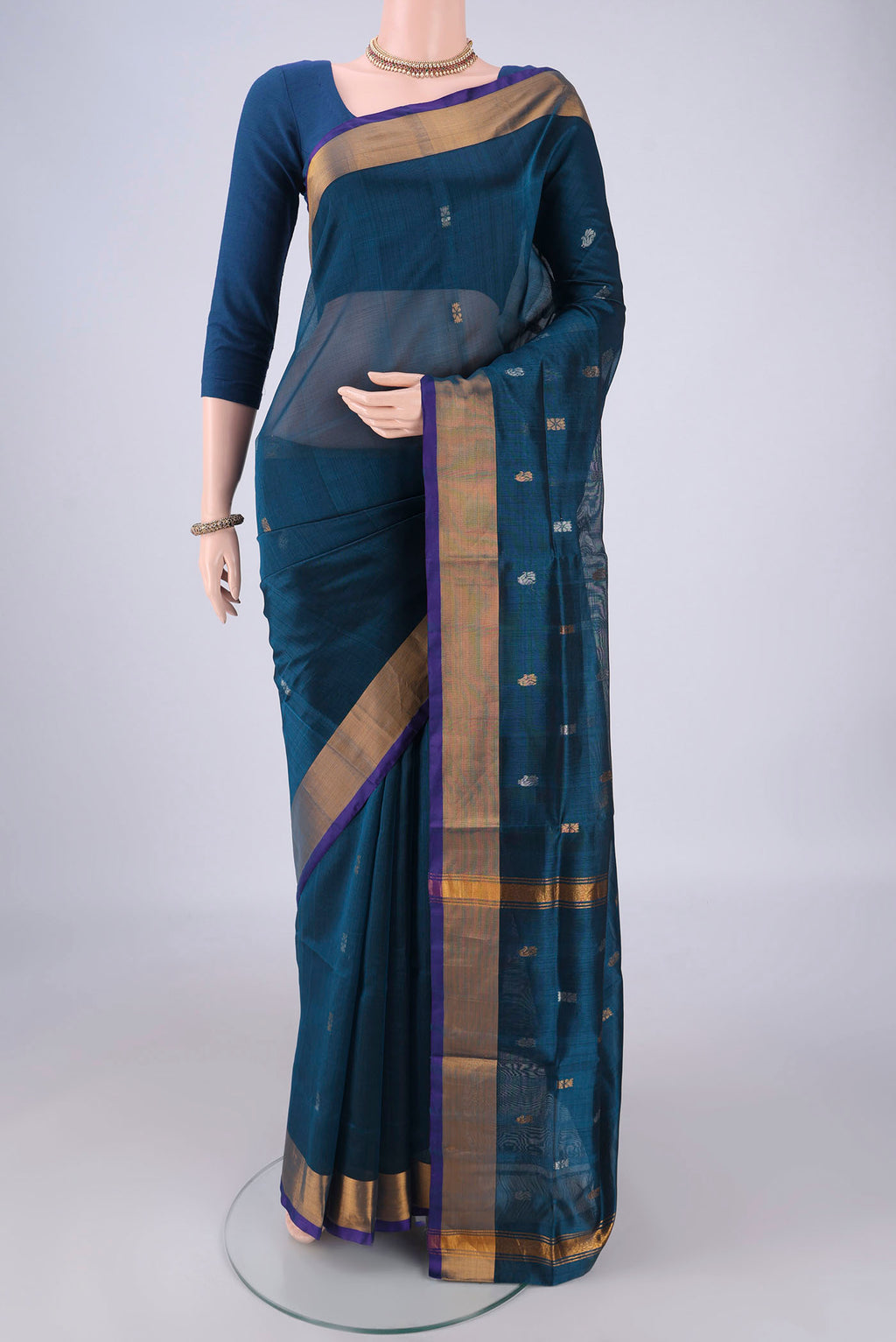 Turquoise Uppada Silk Saree with Zari Butta on the body and Zari Border.  displayed on a mannequin