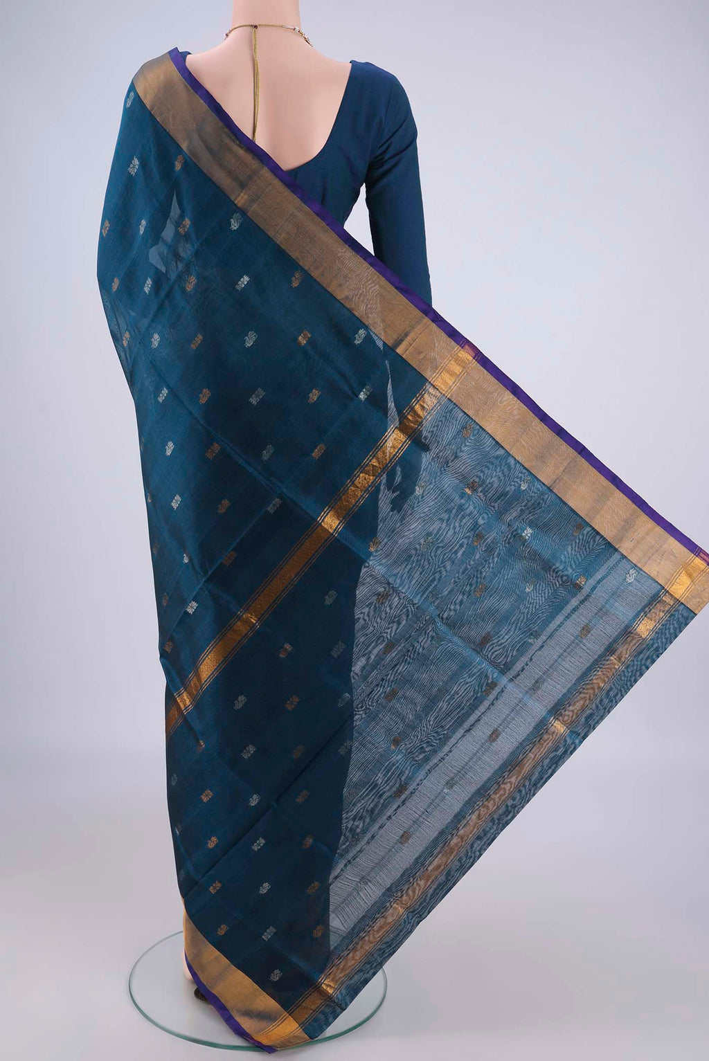 Flat view of Turquoise Uppada Silk Saree with Zari Butta on the body and Zari Border. 