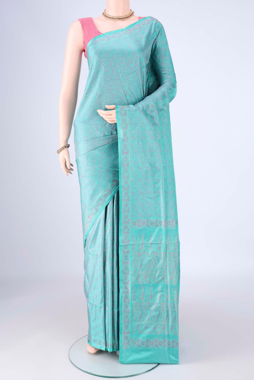 Turquoise Banarasi Tanchoi Silk Saree with Jacquard design on the body and Zari And Thread Border.  displayed on a mannequin