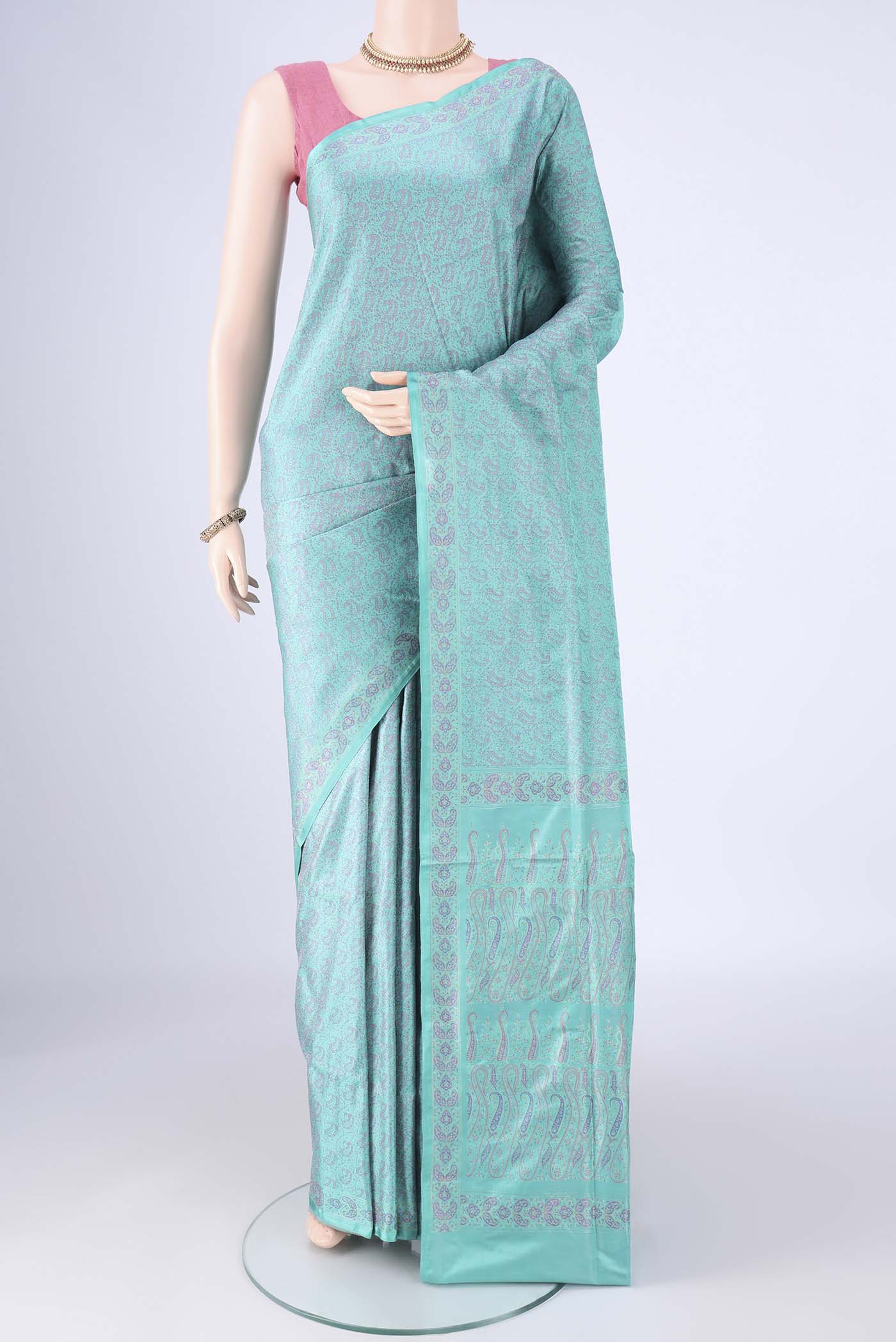 Turquoise Banarasi Tanchoi Silk Saree with Jacquard design on the body and Zari And Thread Border.  displayed on a mannequin