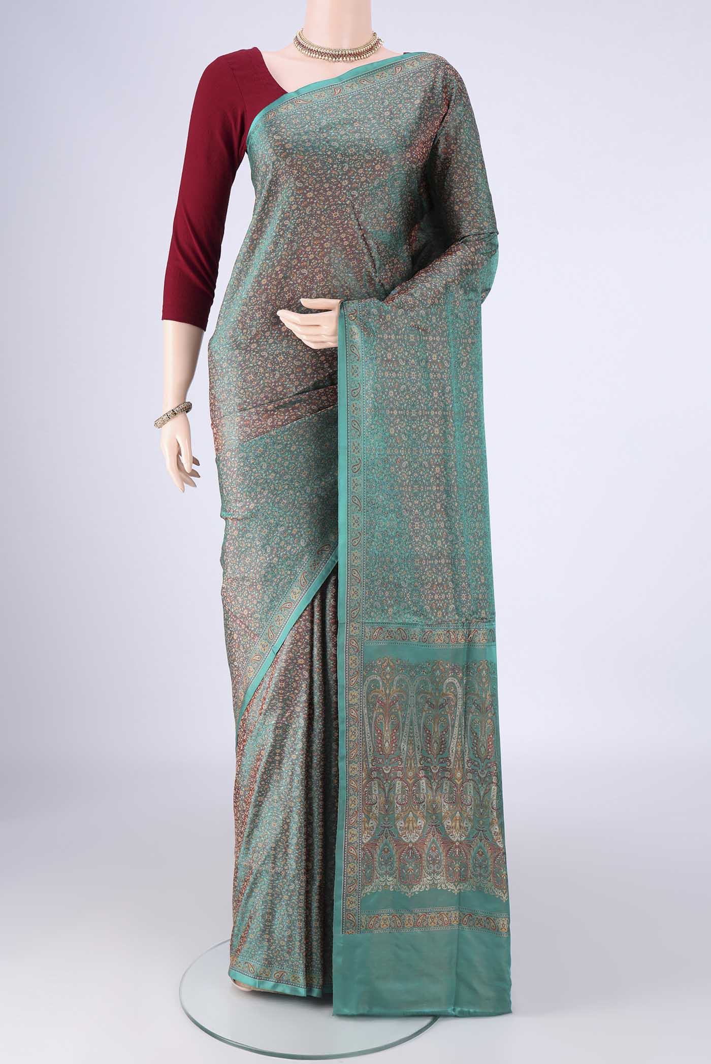 Sea Green Banarasi Tanchoi Silk Saree with Jacquard design on the body and Zari And Thread Border.  displayed on a mannequin