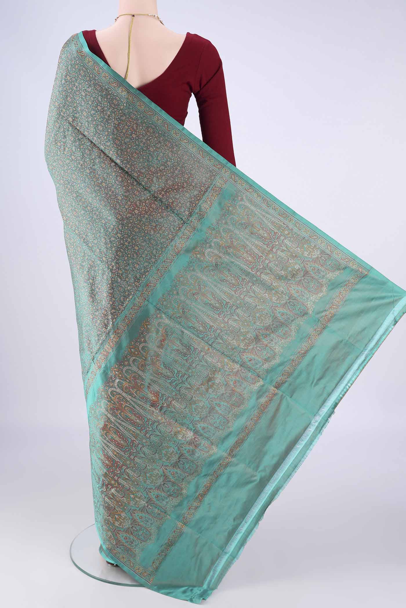 Flat view of Sea Green Banarasi Tanchoi Silk Saree with Jacquard design on the body and Zari And Thread Border. 