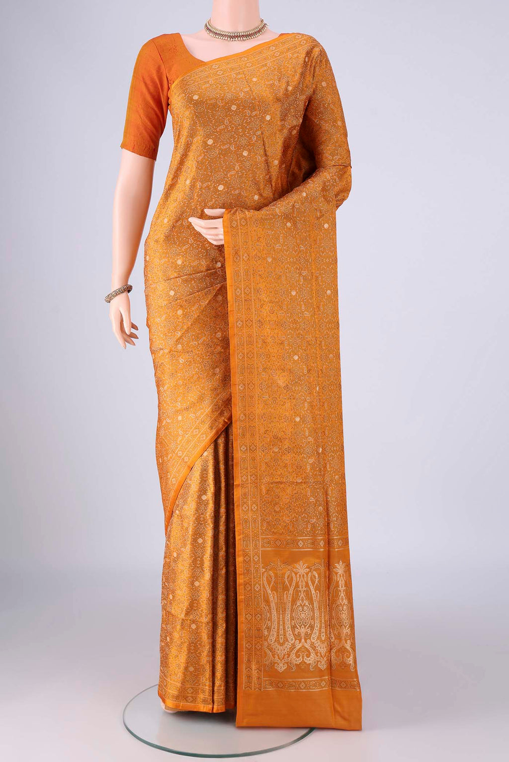 Mustard Banarasi Tanchoi Silk Saree with Jacquard design on the body and Zari And Thread Border.  displayed on a mannequin