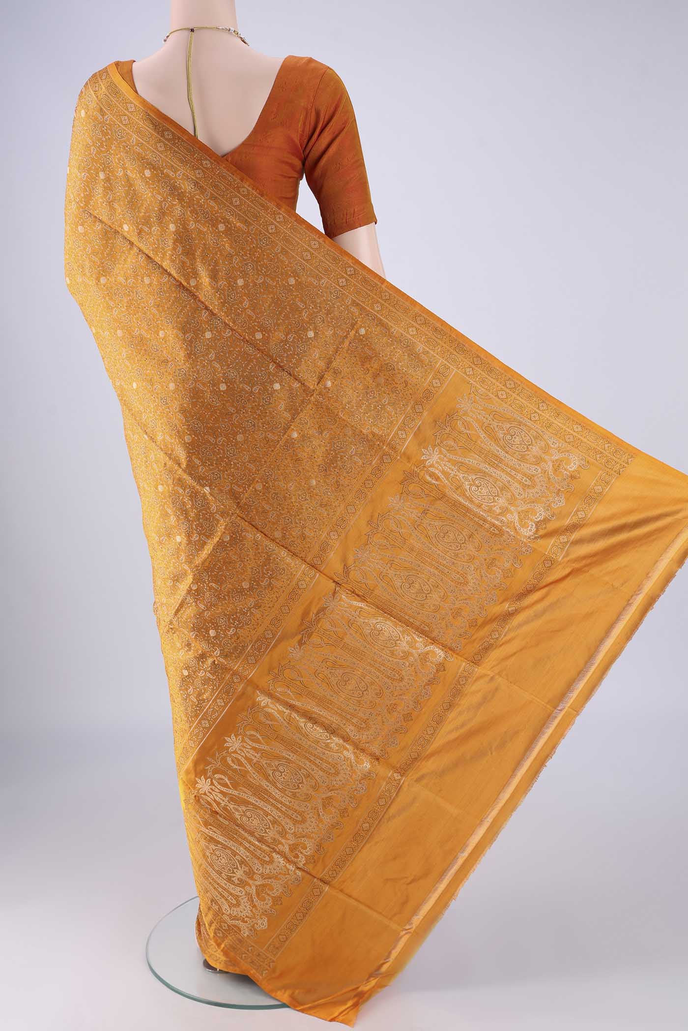 Flat view of Mustard Banarasi Tanchoi Silk Saree with Jacquard design on the body and Zari And Thread Border. 