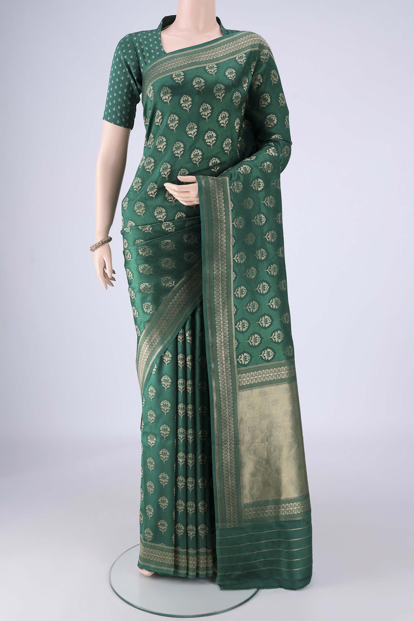 Bottle Green Banarasi Silk Saree with Jacquard With Zari Butta on the body and Zari Border.  displayed on a mannequin