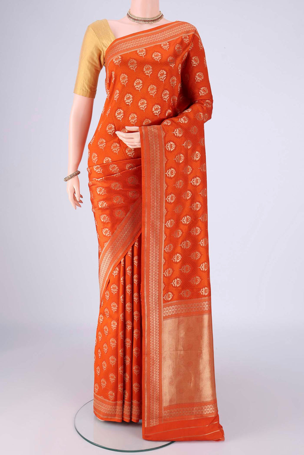 Rust Banarasi Silk Saree with Jacquard With Zari Butta on the body and Zari Border.  displayed on a mannequin