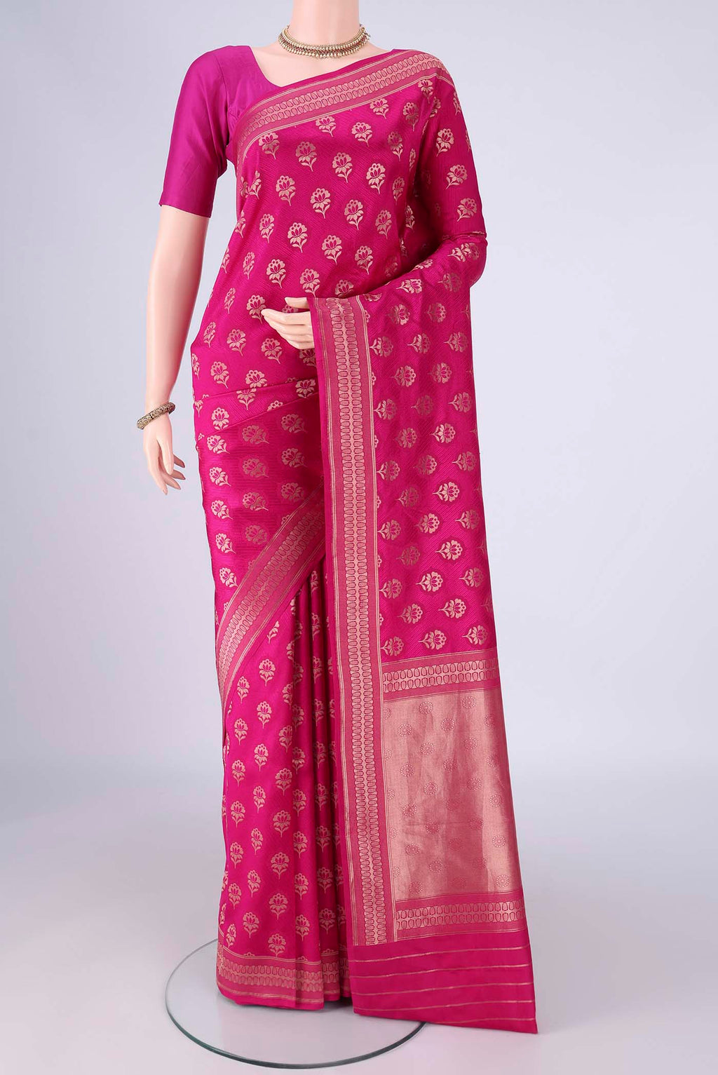Rani Pink Banarasi Silk Saree with Jacquard With Zari Butta on the body and Zari Border.  displayed on a mannequin