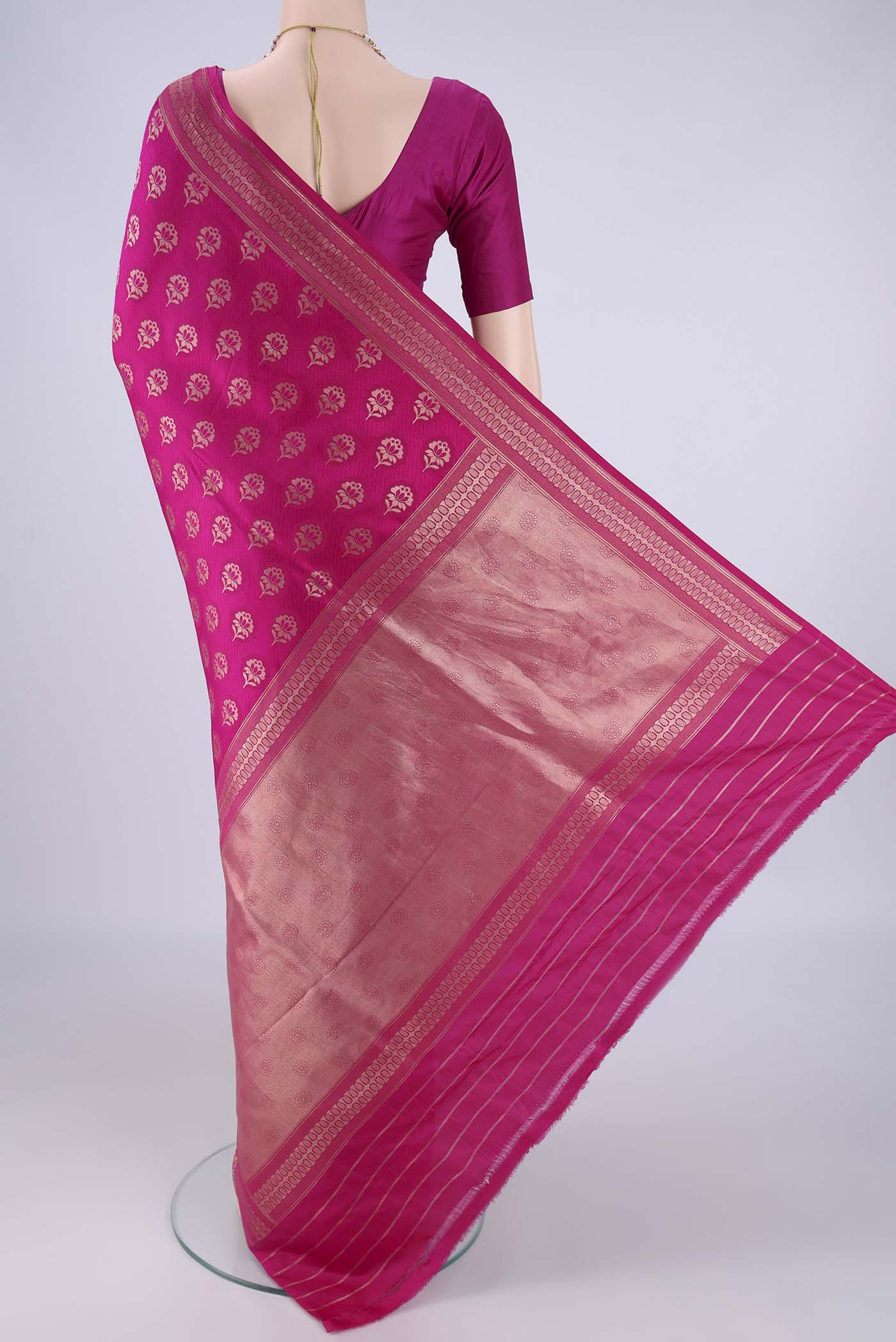 Flat view of Rani Pink Banarasi Silk Saree with Jacquard With Zari Butta on the body and Zari Border. 