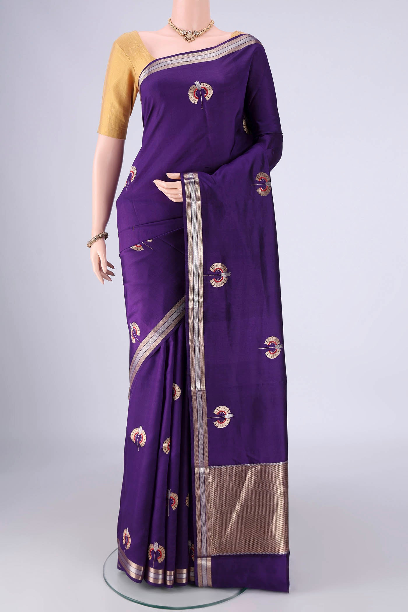 Violet Banarasi Silk Saree with Zari And Thread Butta on the body and Zari Border.  displayed on a mannequin