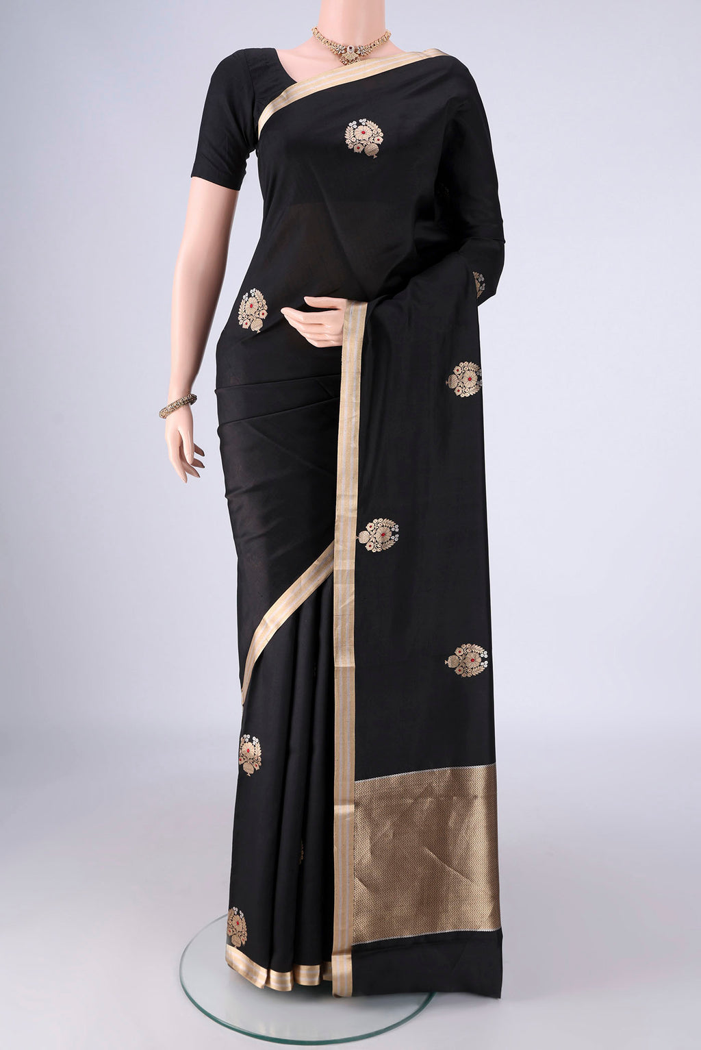 Black Banarasi Silk Saree with Zari Butta on the body and Zari Border.  displayed on a mannequin