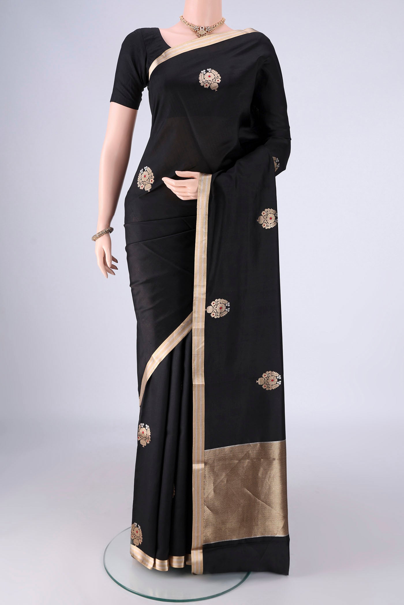 Black Banarasi Silk Saree with Zari Butta on the body and Zari Border.  displayed on a mannequin