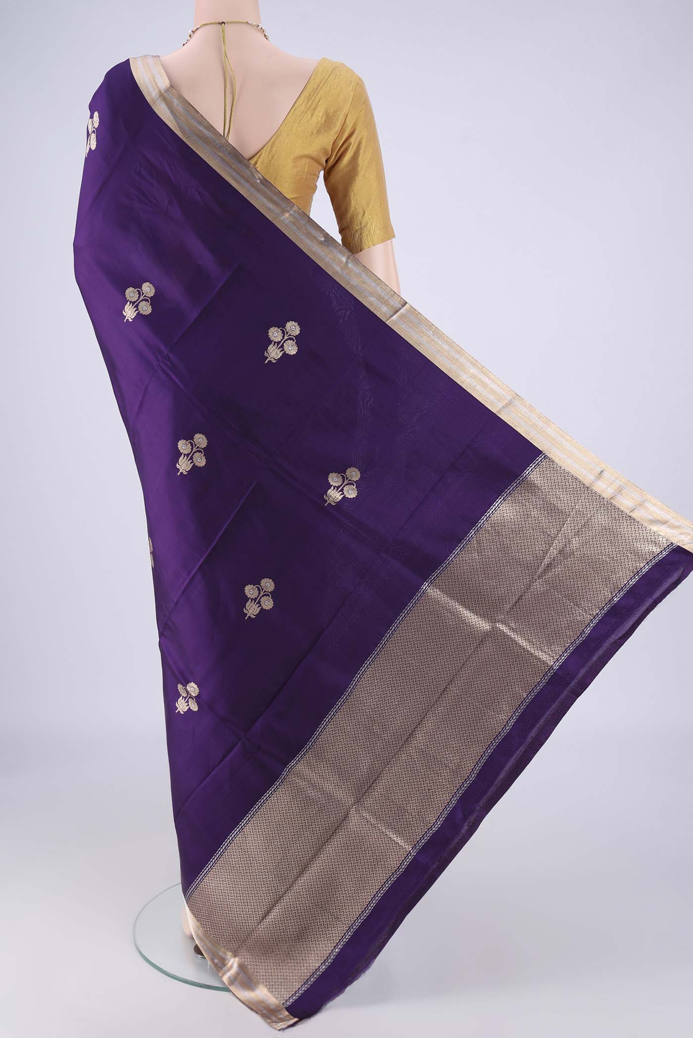 Flat view of Violet Banarasi Silk Saree with Zari Butta on the body and Zari Border. 