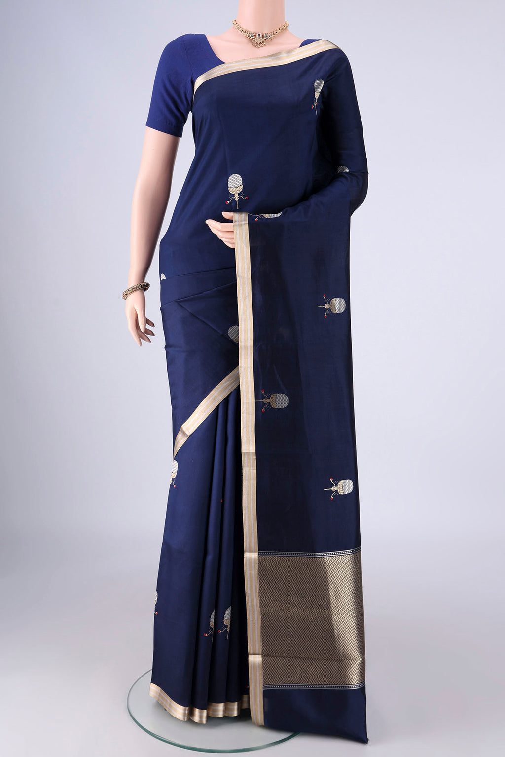 Navy Blue Banarasi Silk Saree with Zari Butta on the body and Zari Border.  displayed on a mannequin