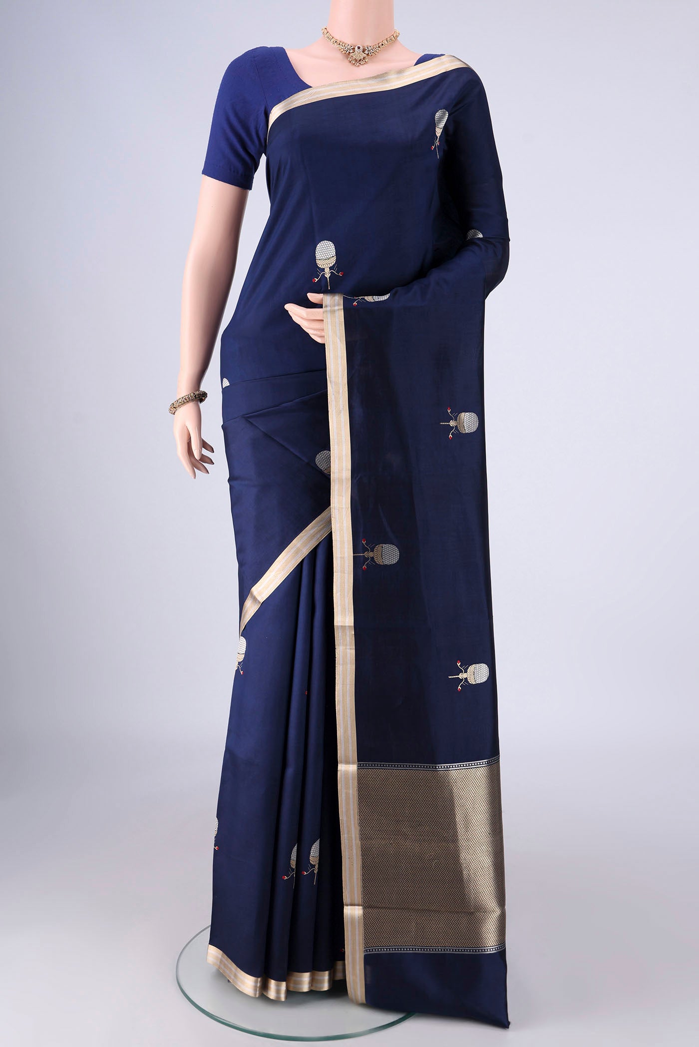 Navy Blue Banarasi Silk Saree with Zari Butta on the body and Zari Border.  displayed on a mannequin