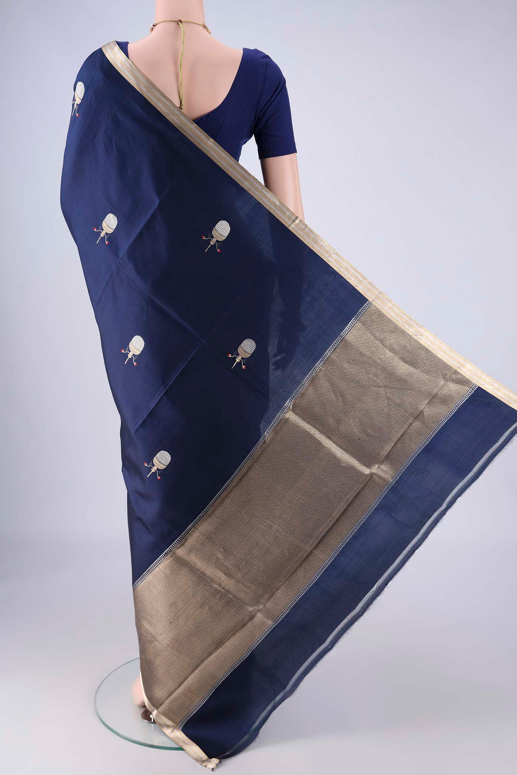 Flat view of Navy Blue Banarasi Silk Saree with Zari Butta on the body and Zari Border. 
