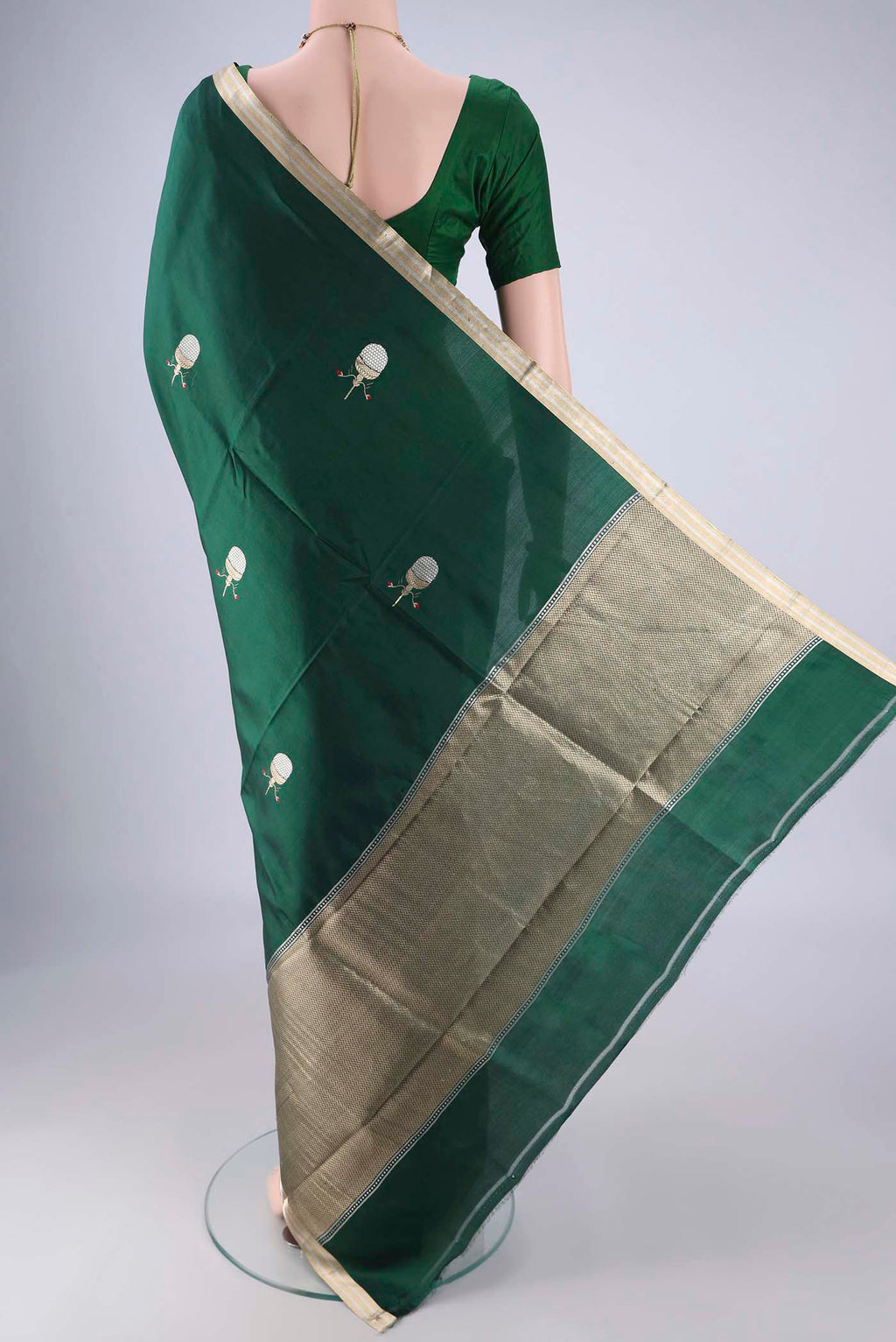 Flat view of Bottle Green Banarasi Silk Saree with Zari Butta on the body and Zari Border. 