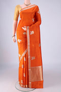 Rust Banarasi Silk Saree with Zari Butta on the body and Zari Border.  displayed on a mannequin