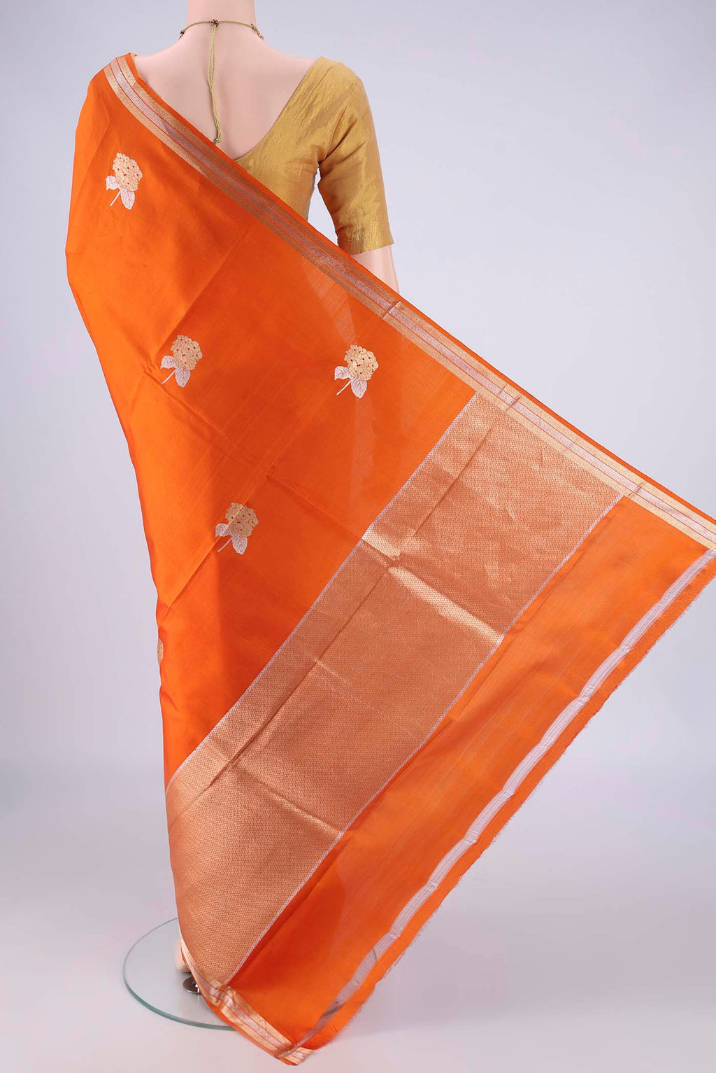 Flat view of Rust Banarasi Silk Saree with Zari Butta on the body and Zari Border. 