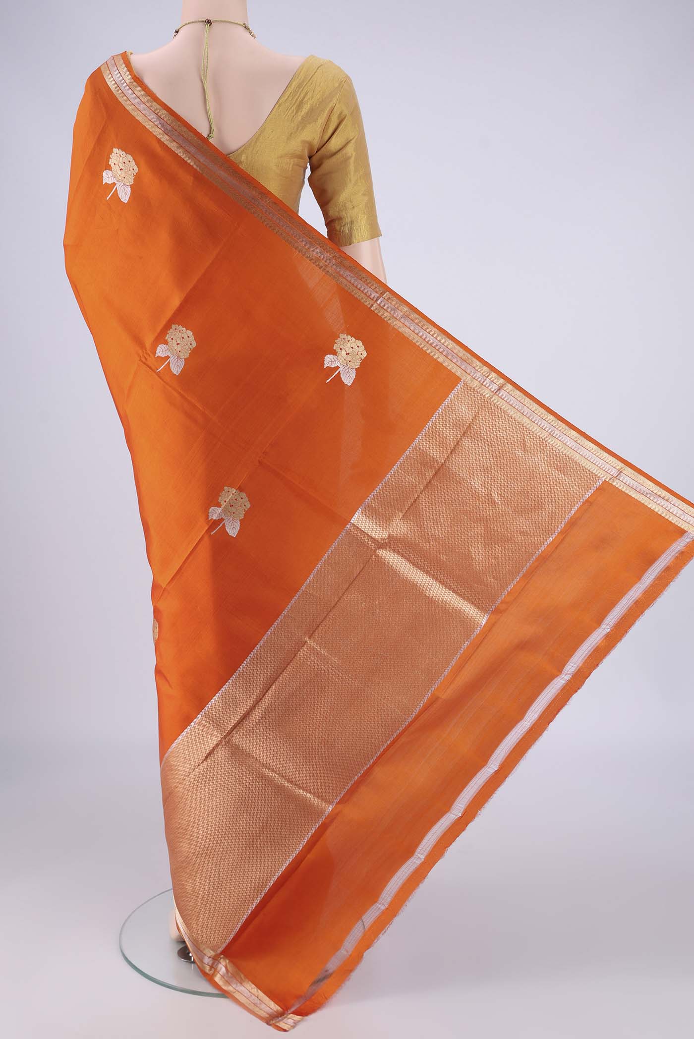 Flat view of Rust Banarasi Silk Saree with Zari Butta on the body and Zari Border. 