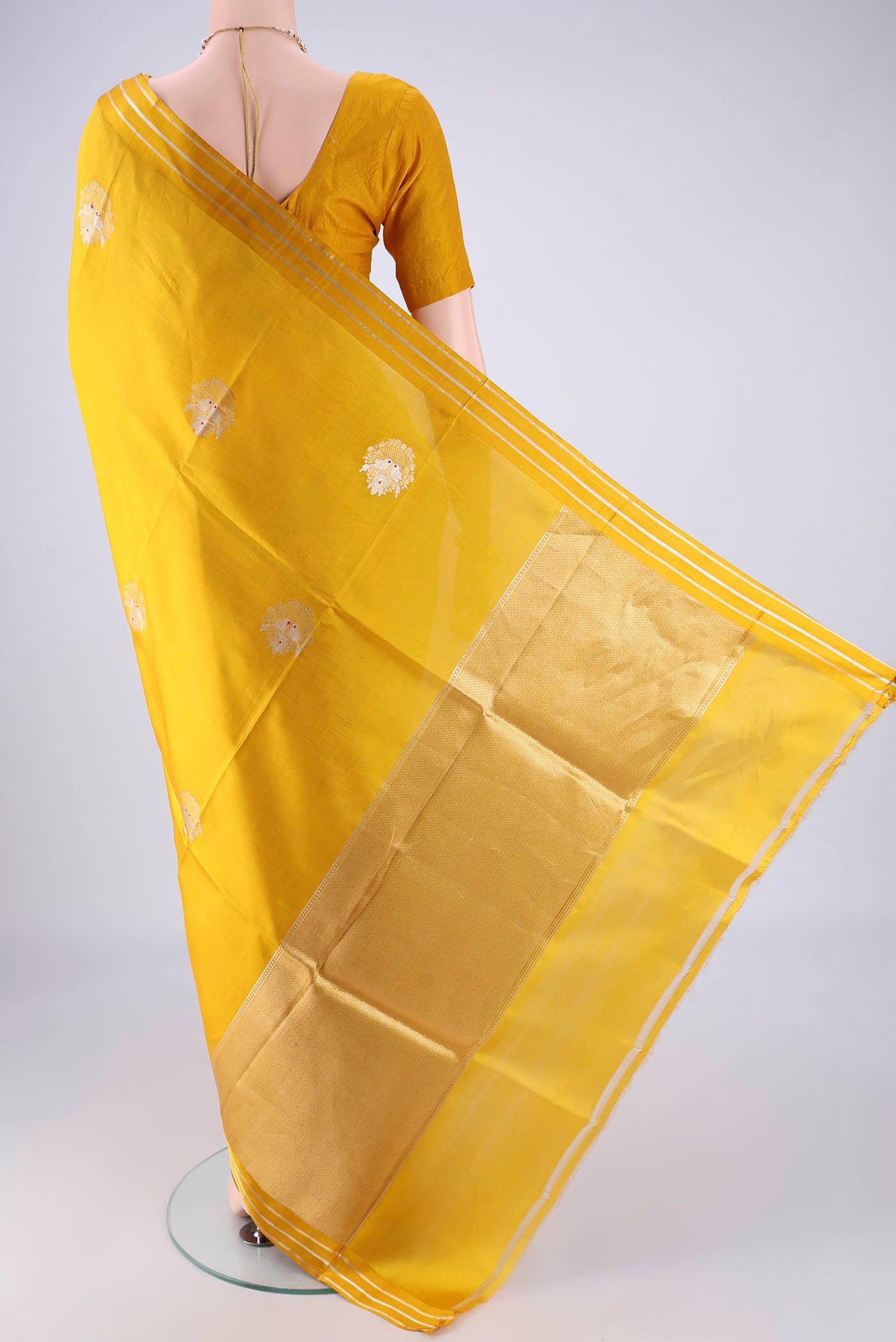 Flat view of Yellow Banarasi Silk Saree with Zari Butta on the body and Zari Border. 