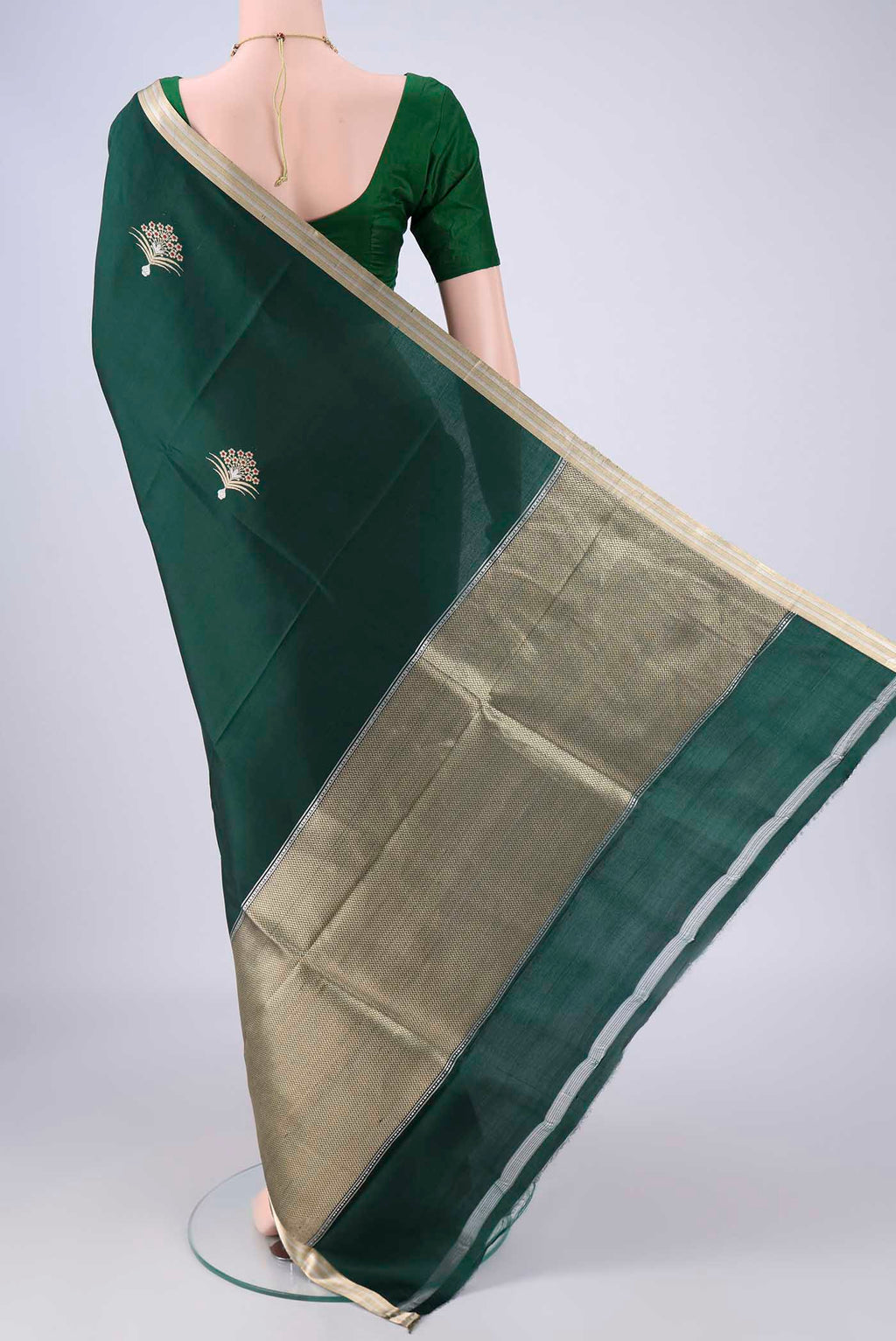 Flat view of Bottle Green Banarasi Silk Saree with Zari Butta on the body and Zari Border. 